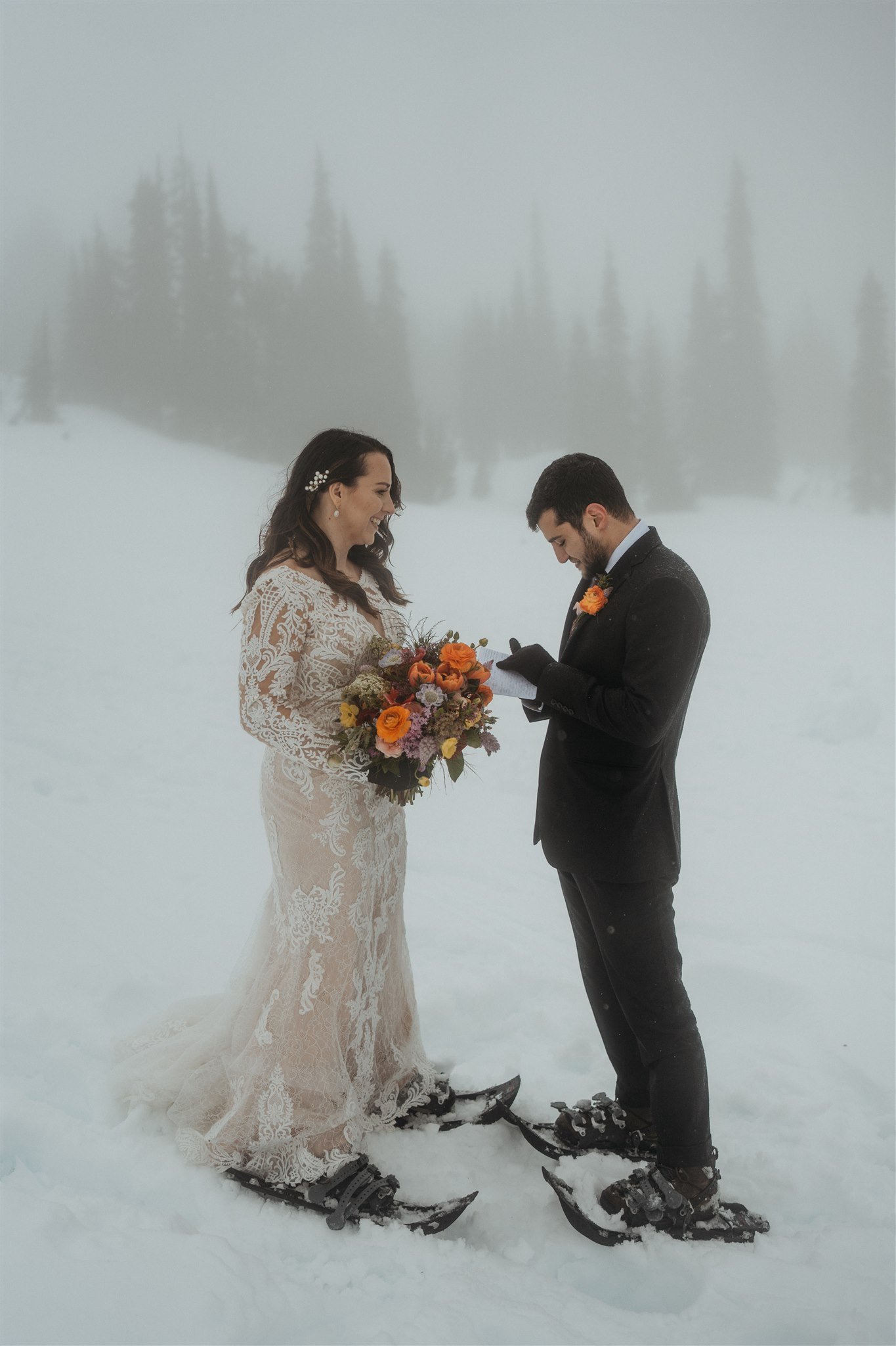 Bride and groom exchanging vows in front of Mt Rainier during their hiking elopement ceremony