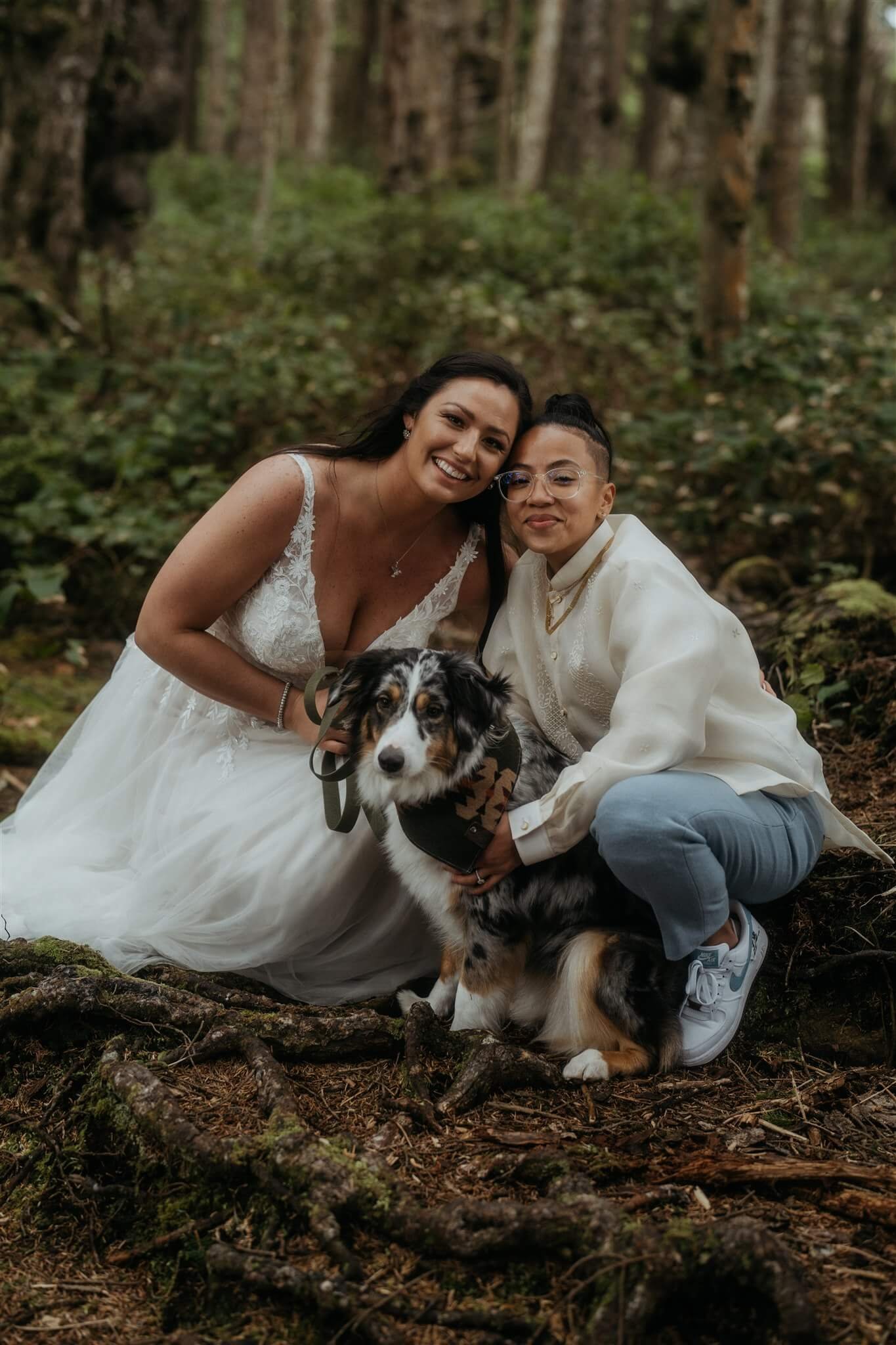 Two brides with dog in the forest during Olympic National Park elopement