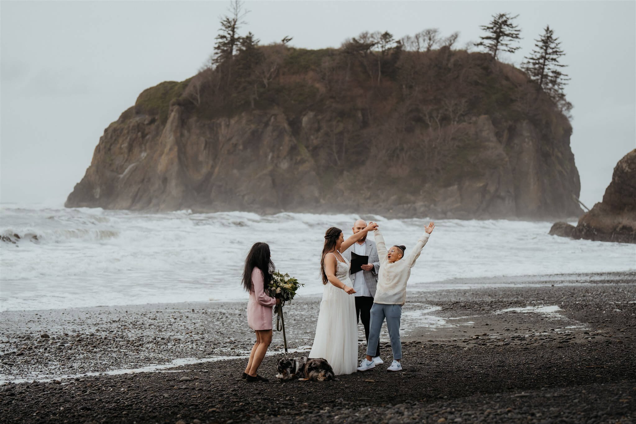 Brides cheer after Ruby Beach elopement ceremony