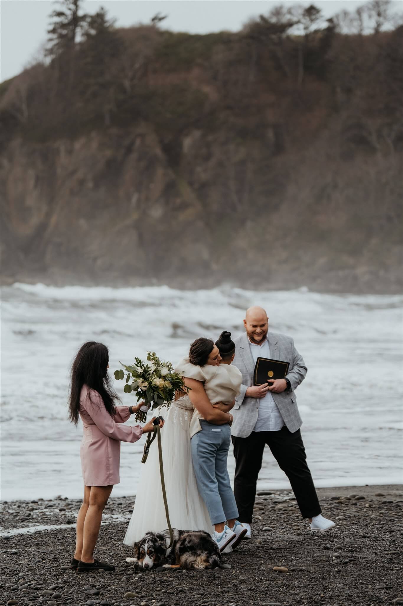 Brides hug after Ruby Beach elopement ceremony