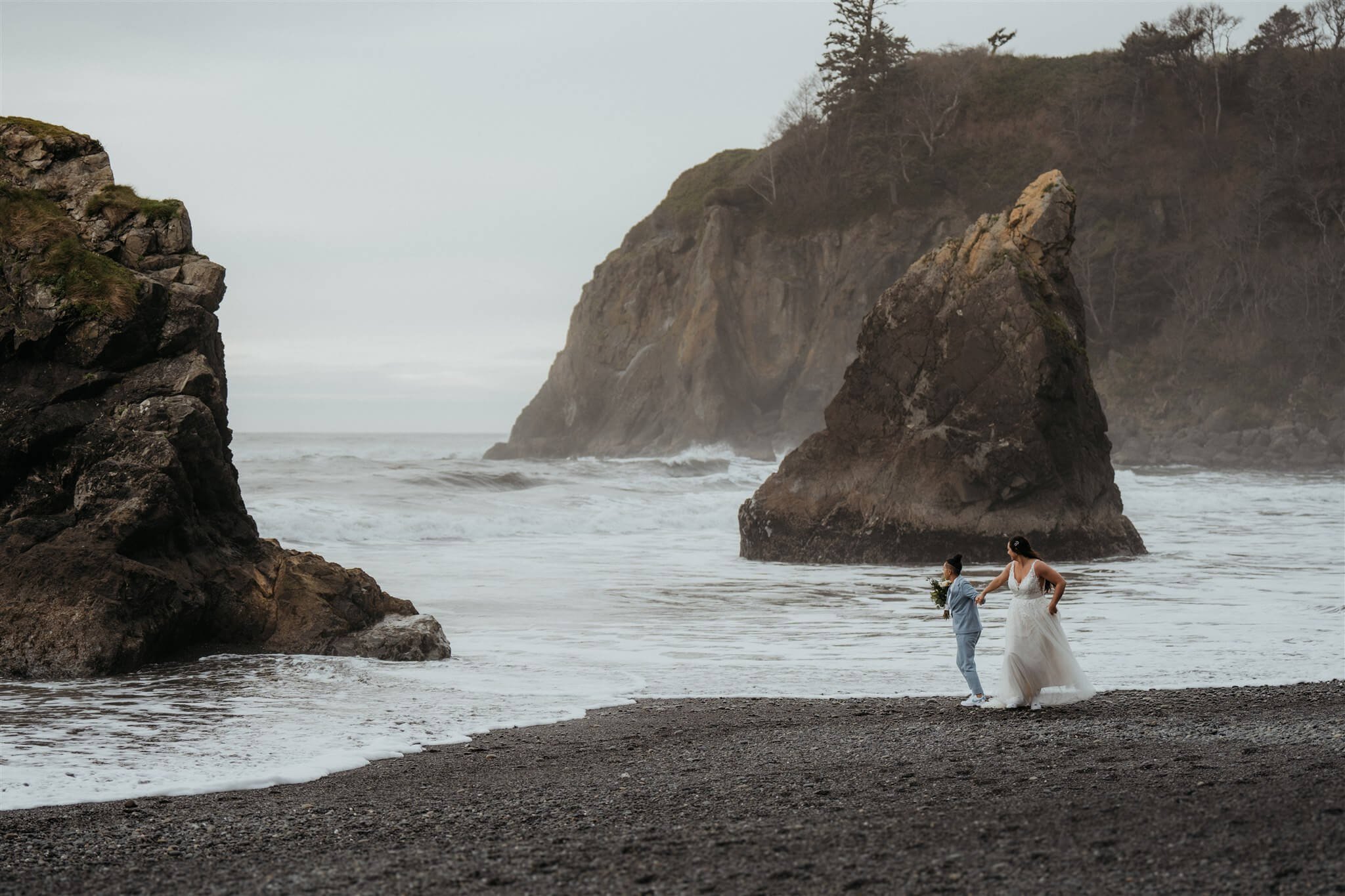 Brides running across Ruby Beach in Olympic National Park