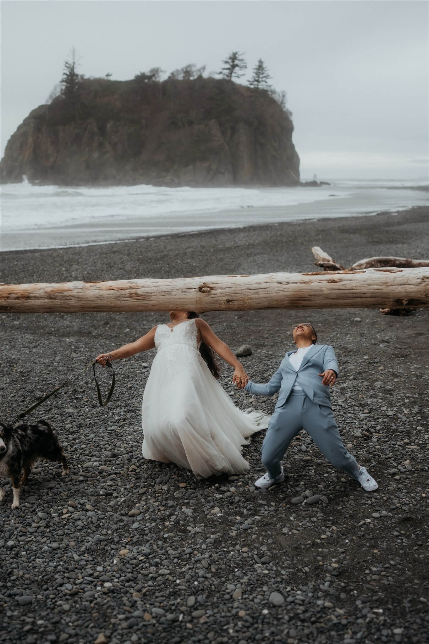 Brides walking under low log at Ruby Beach