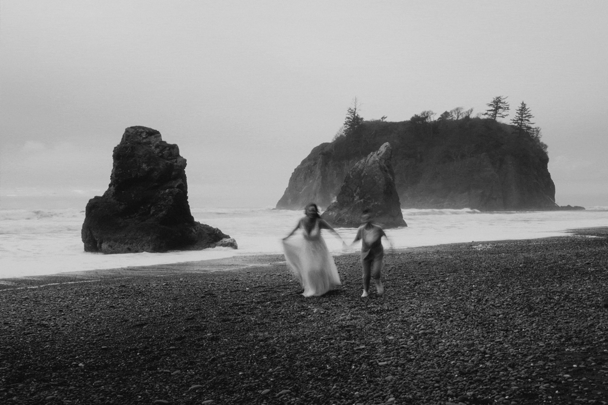 Brides running across the beach at Olympic National Park elopement
