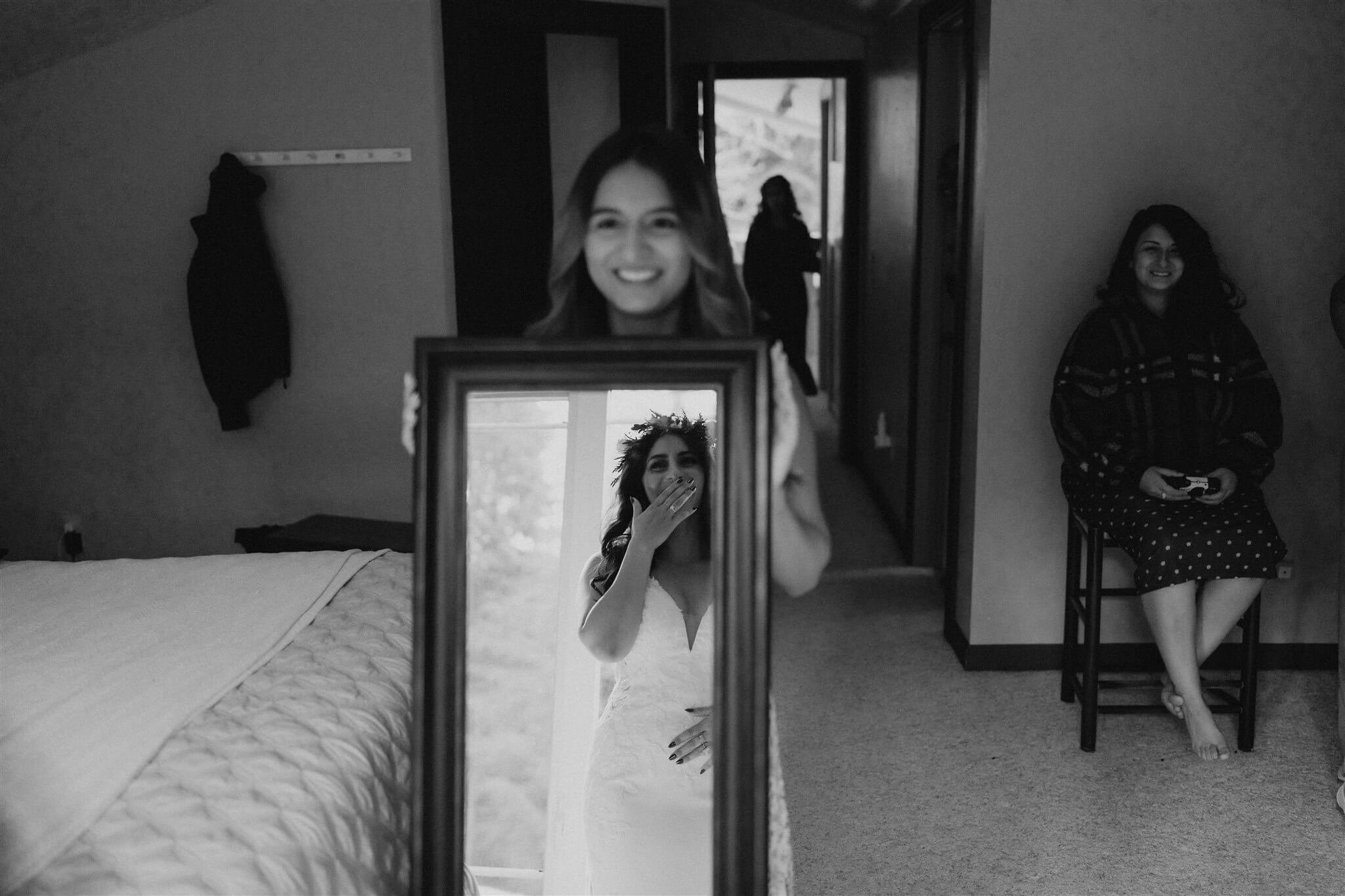 Bride looking in the mirror after getting ready