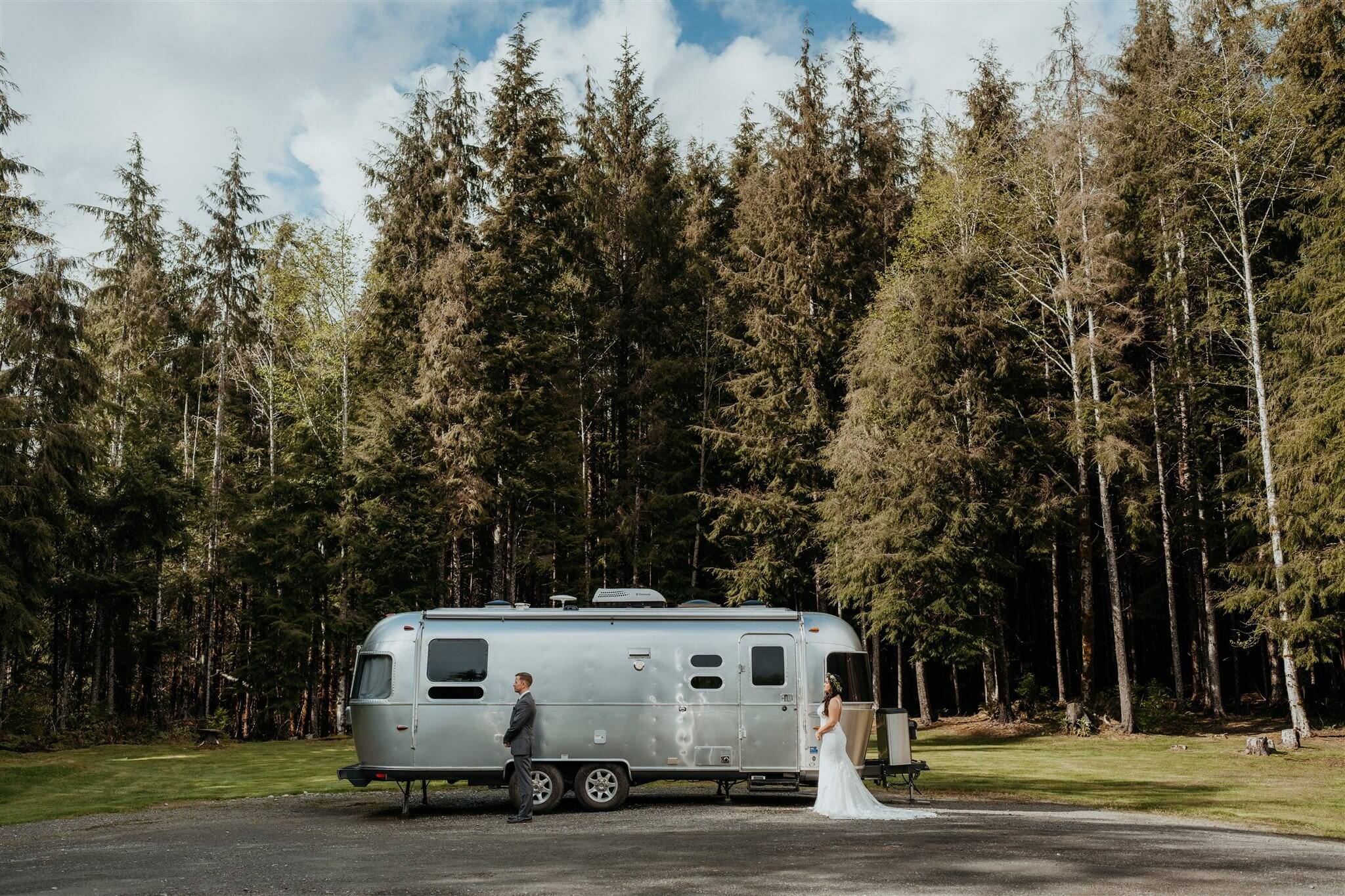 Bride and groom first look next to airstream trailer