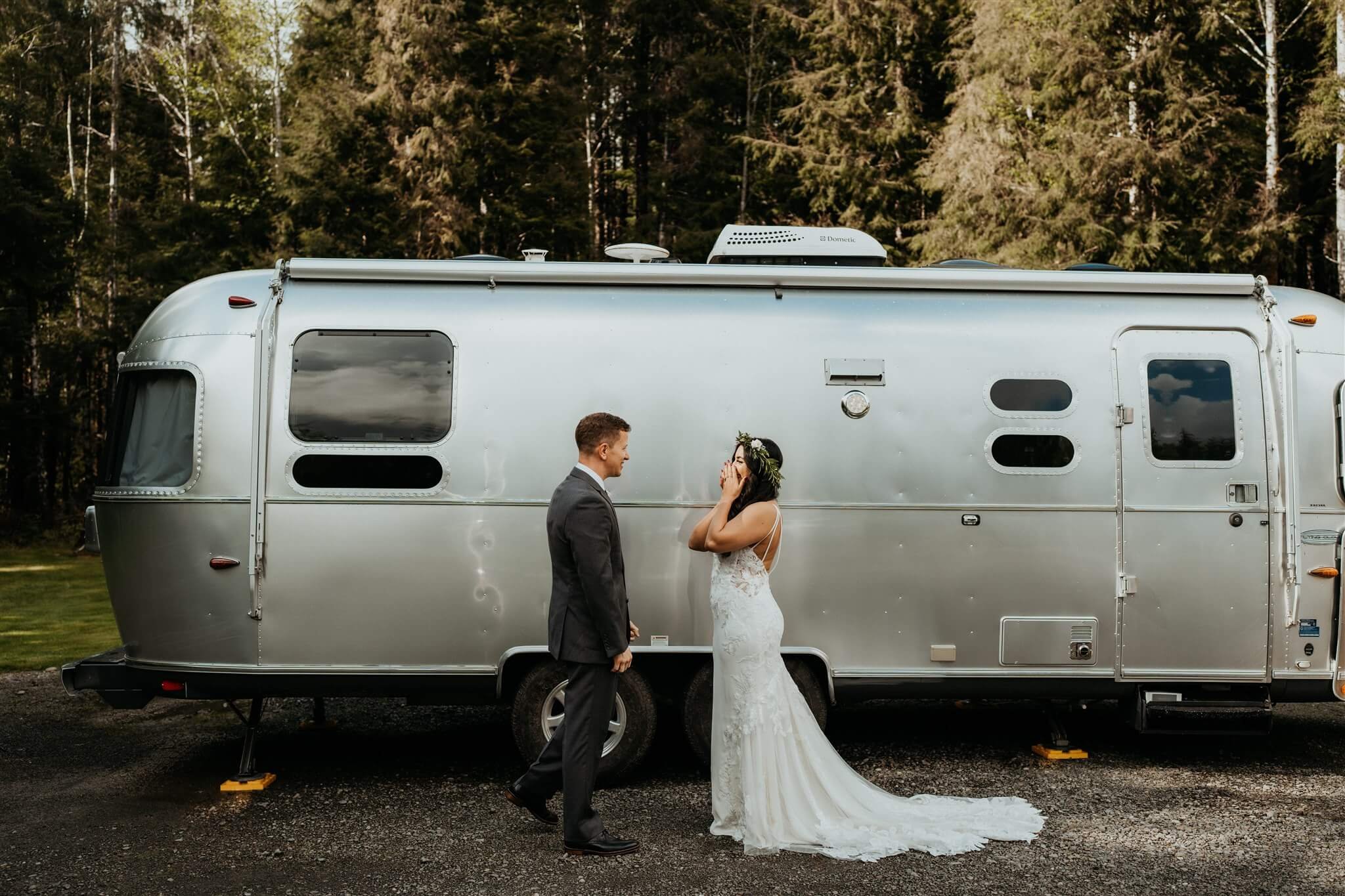 Bride and groom first look next to airstream trailer