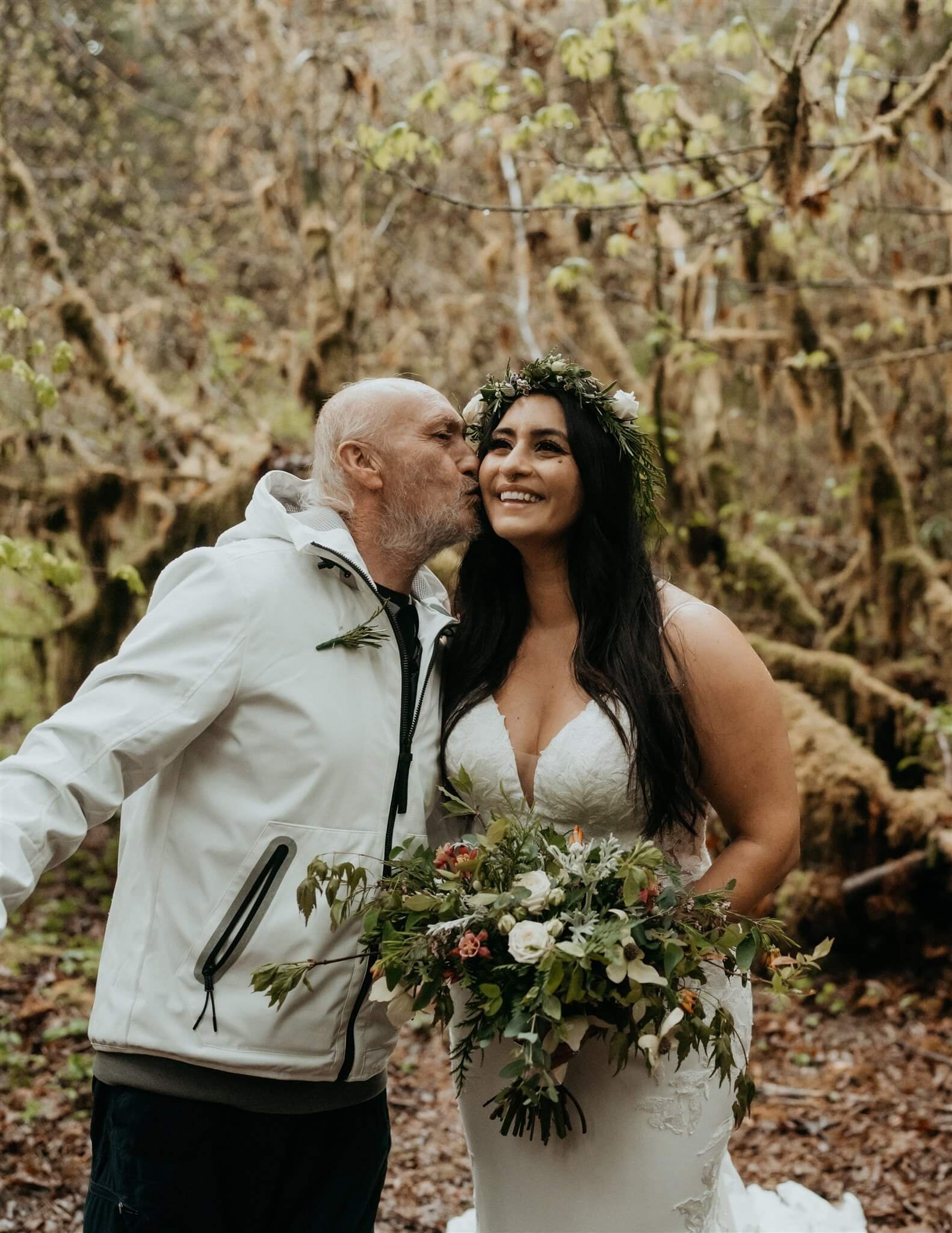 Father kissing bride on the cheek before Hoh Rainforest elopement ceremony