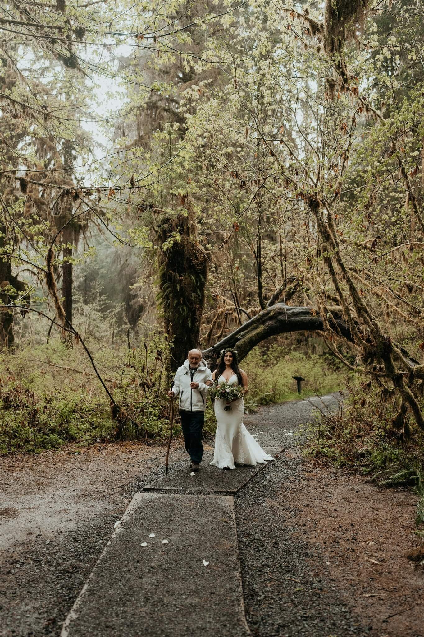 Bride walking down the forest trail during Hoh Rainforest elopement