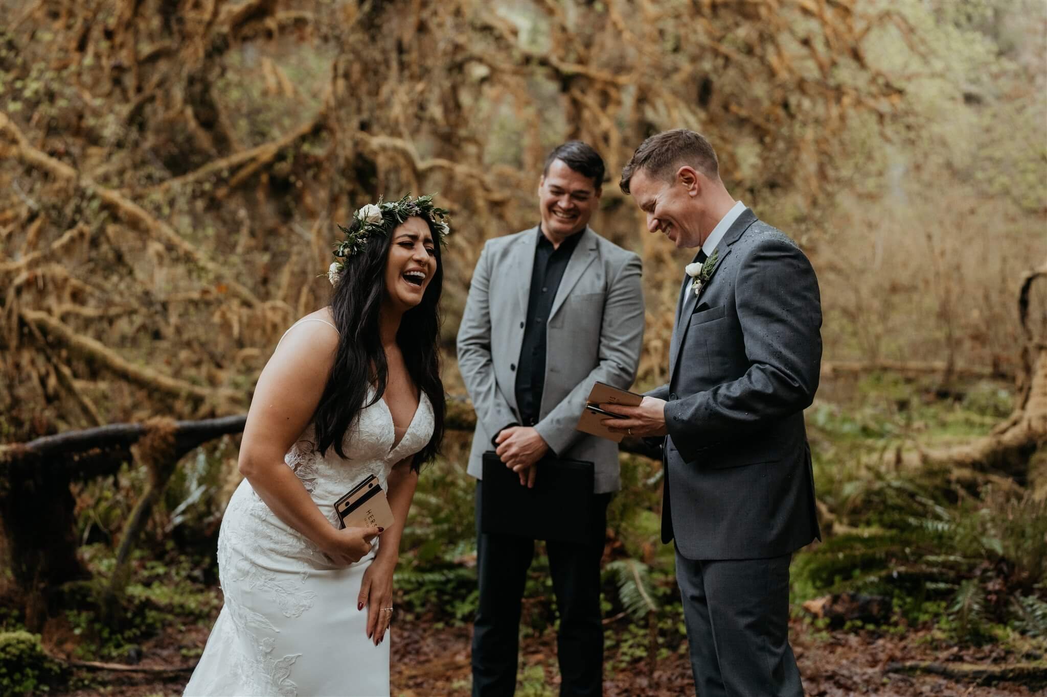 Bride and groom laughing during forest wedding ceremony at Hoh Rainforest