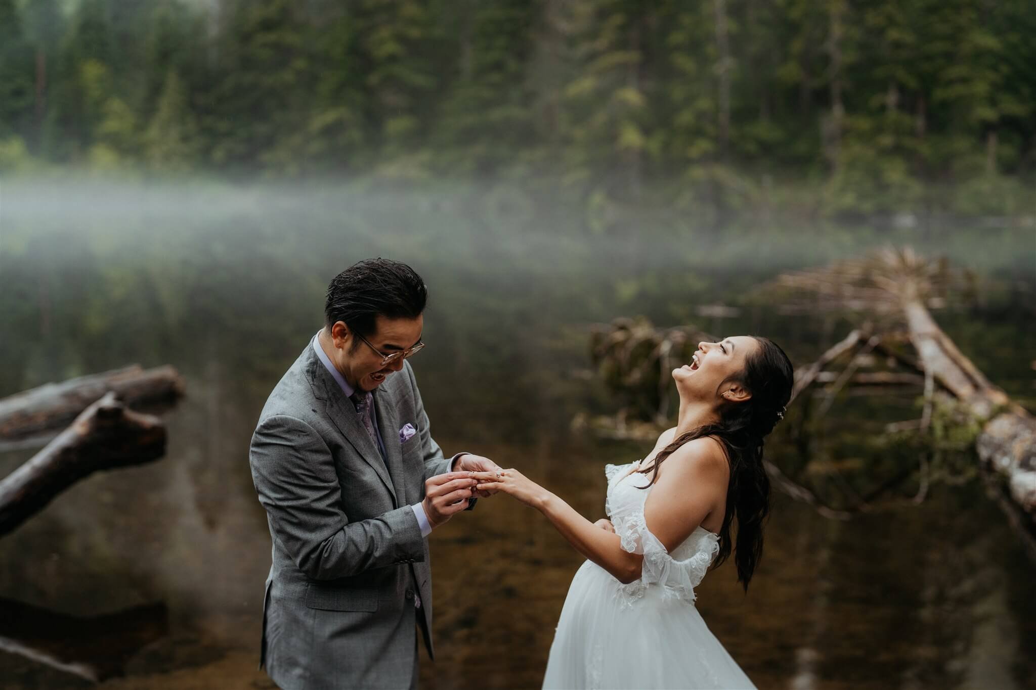 Bride and groom exchange rings near Barclay Lake