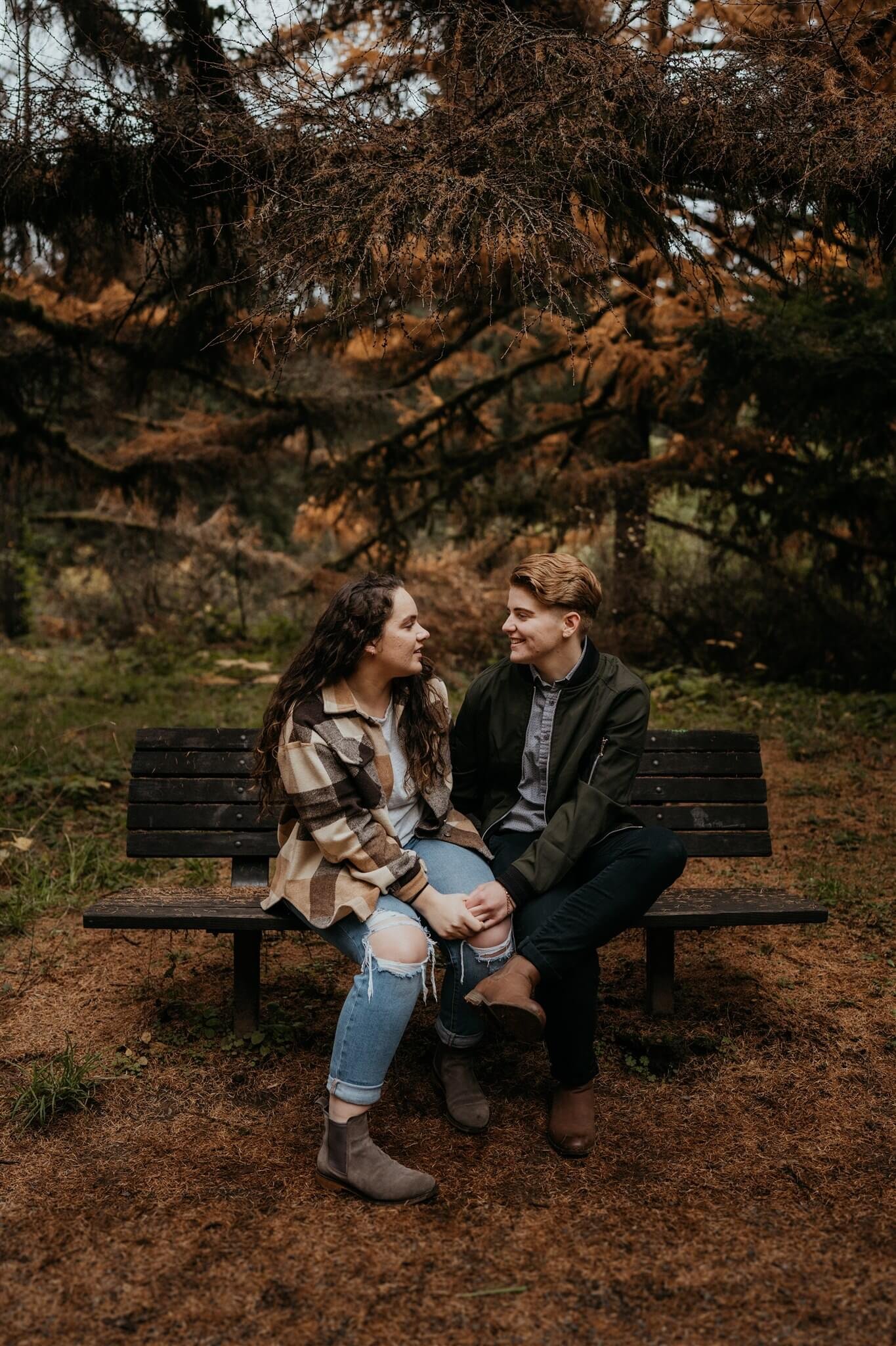 Two women sitting on a bench during Oregon engagement session