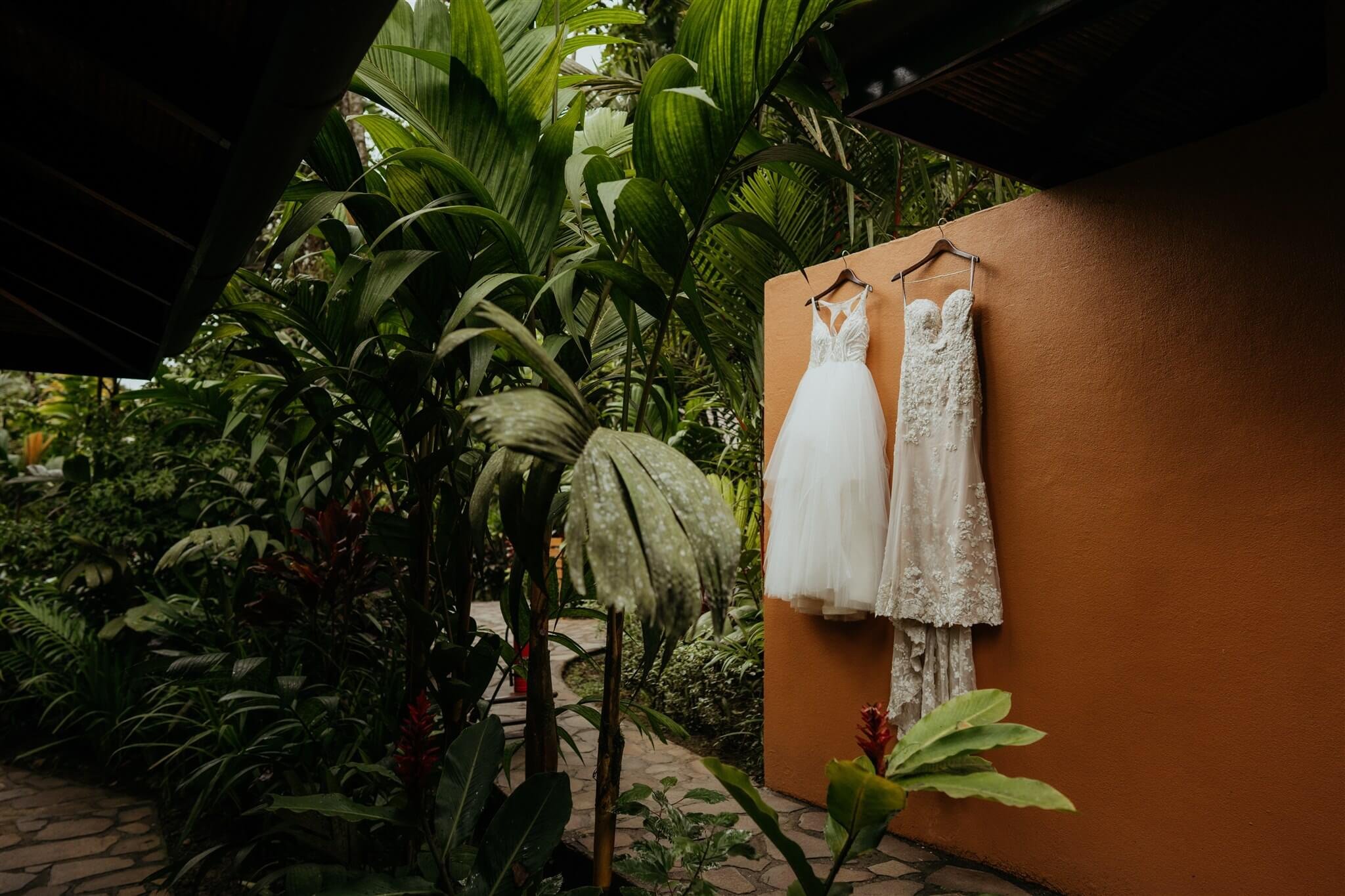 Two wedding dresses hanging at Rio Celeste Hideaway for Costa Rica elopement