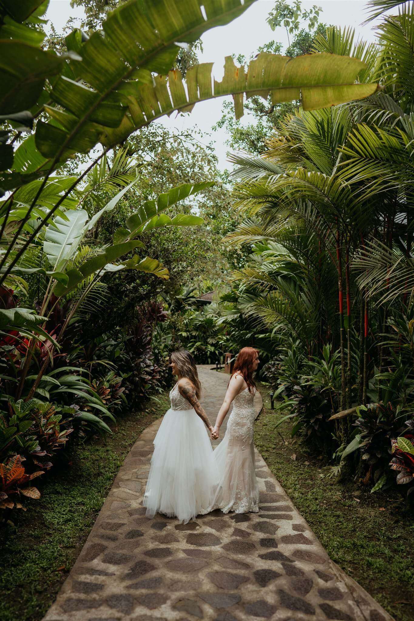 Two brides holding hands before first look at Rio Celeste Hideaway