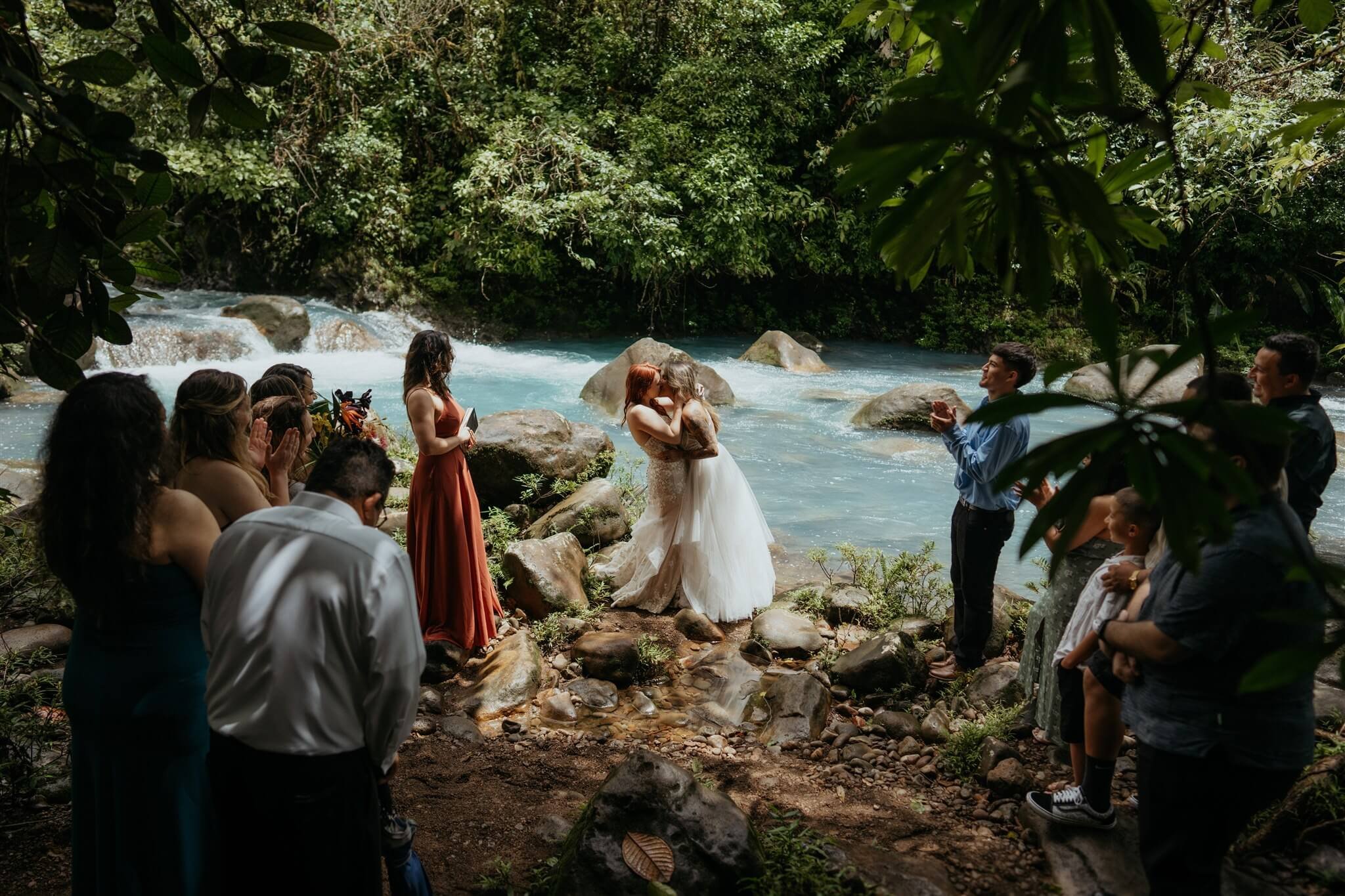 Brides kiss during adventure wedding ceremony in Costa Rica