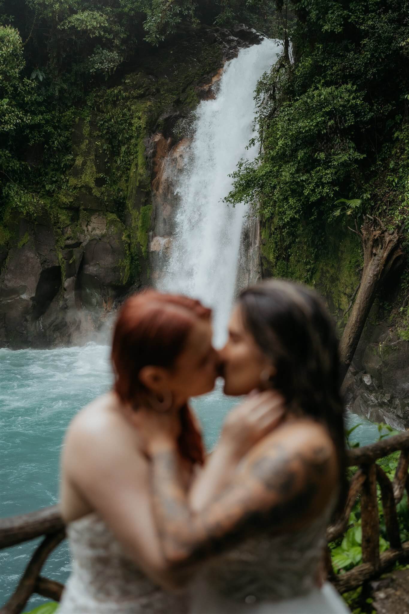 Two brides kiss during couple portraits at Costa Rica elopement