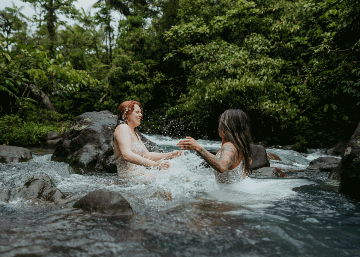 Two brides splash in the river at Costa Rica elopement