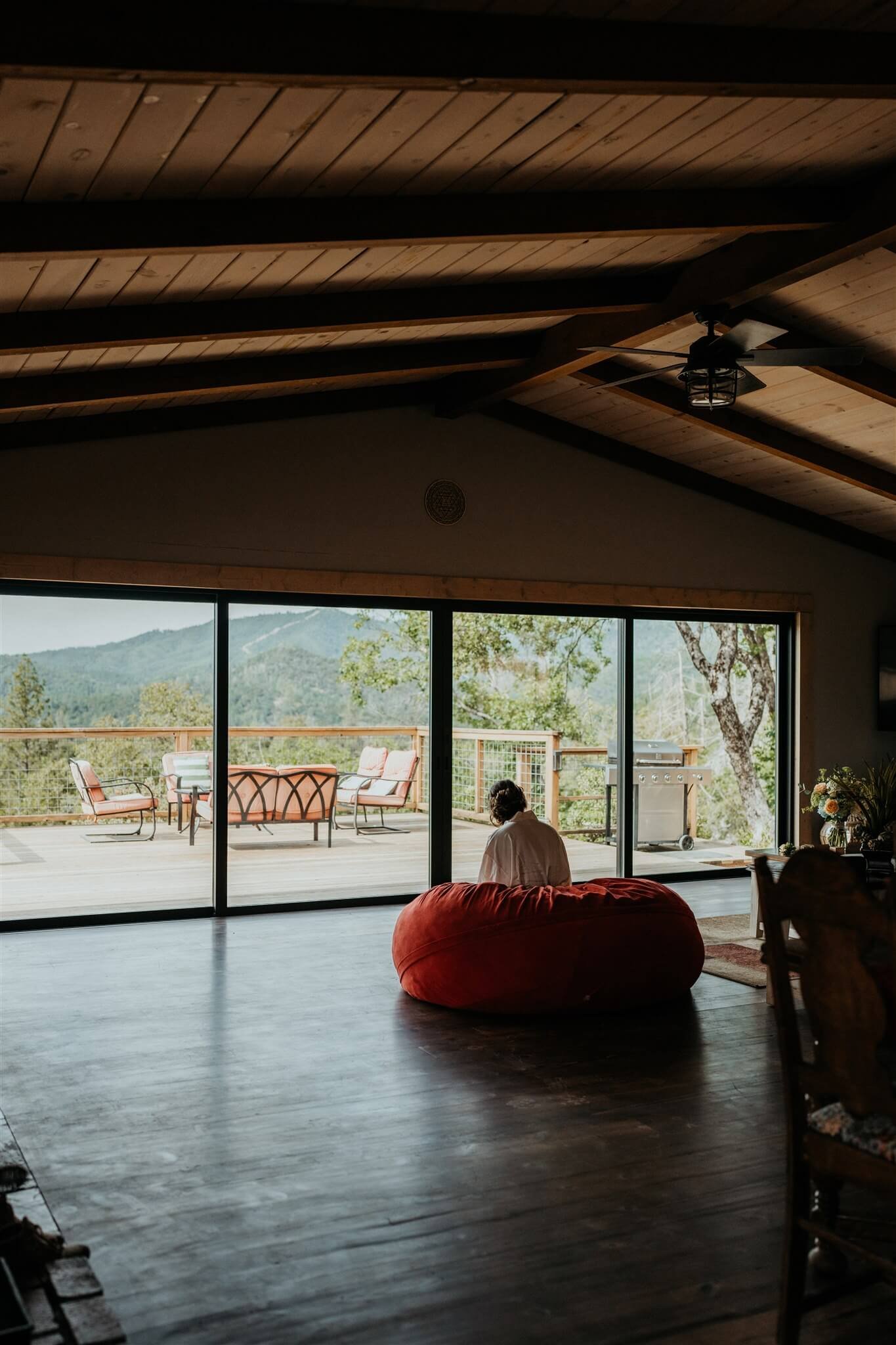 Bride sitting on red bean bag chair writing her vows