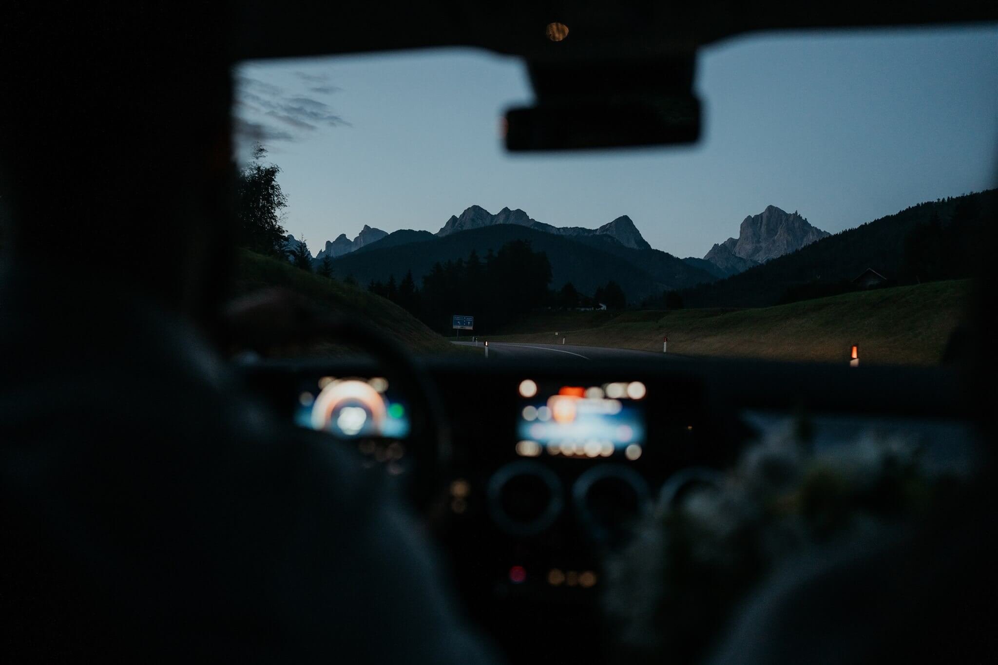 Couple driving at dawn to elopement site in Italy