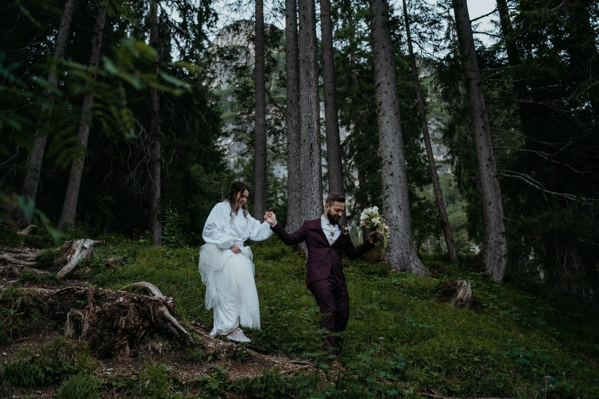 Bride and groom hiking to intimate vow renewal ceremony site in Italy