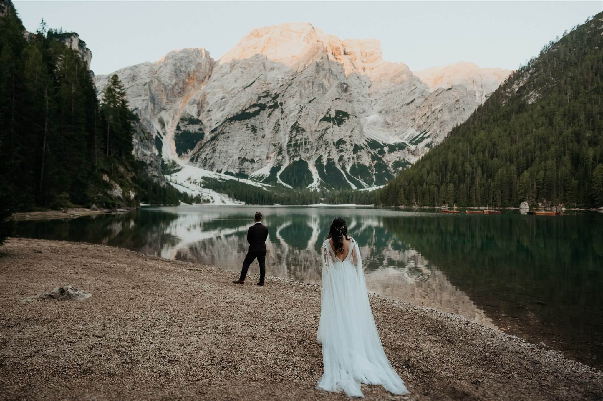 Bride and groom first look at Lago di Braies in Italy