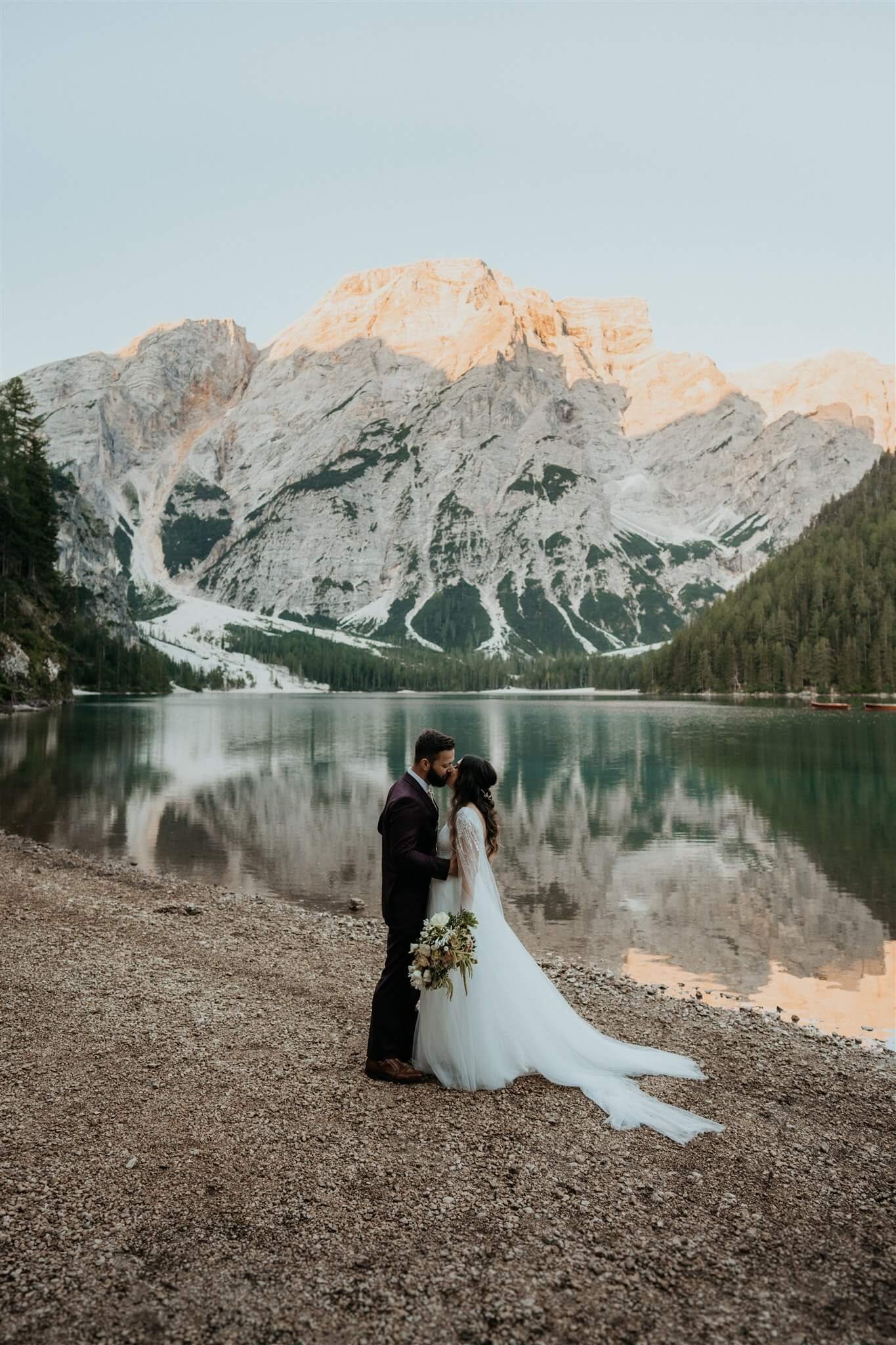 Bride and groom kiss after first look at Lago di Braies