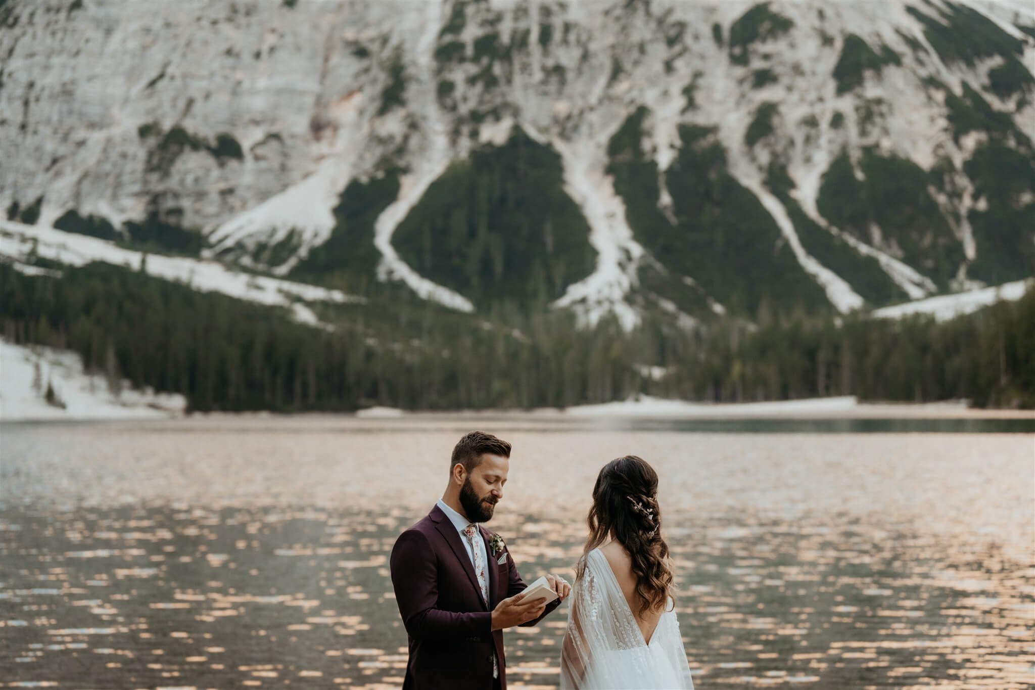 Bride and groom exchange vows by the lake at intimate vow renewal in Italy