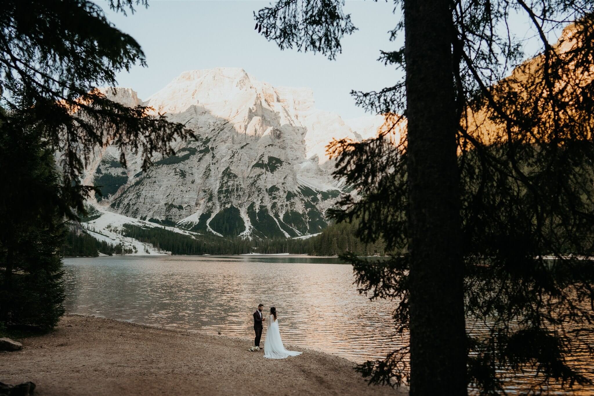 Bride and groom exchange vows by the lake at intimate vow renewal in Italy