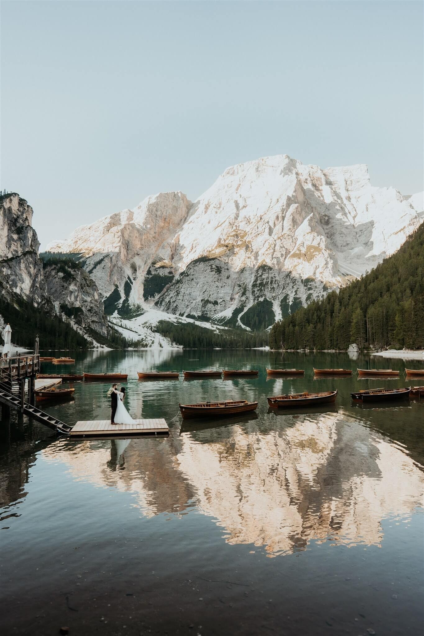 Bride and groom couple portraits at the boat dock at Lago di Braies intimate vow renewal