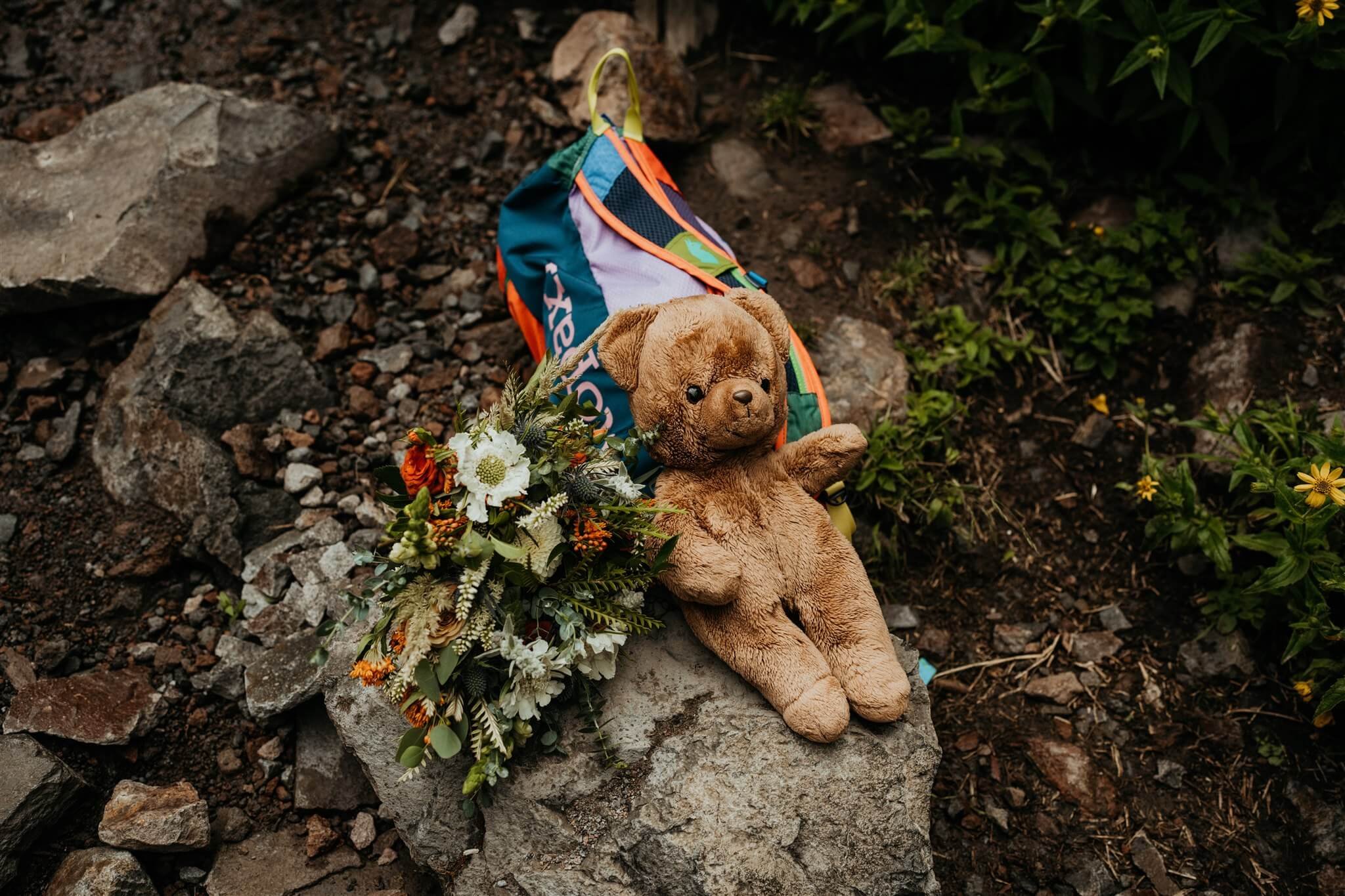 Waterfall elopement flowers and stuffed bear