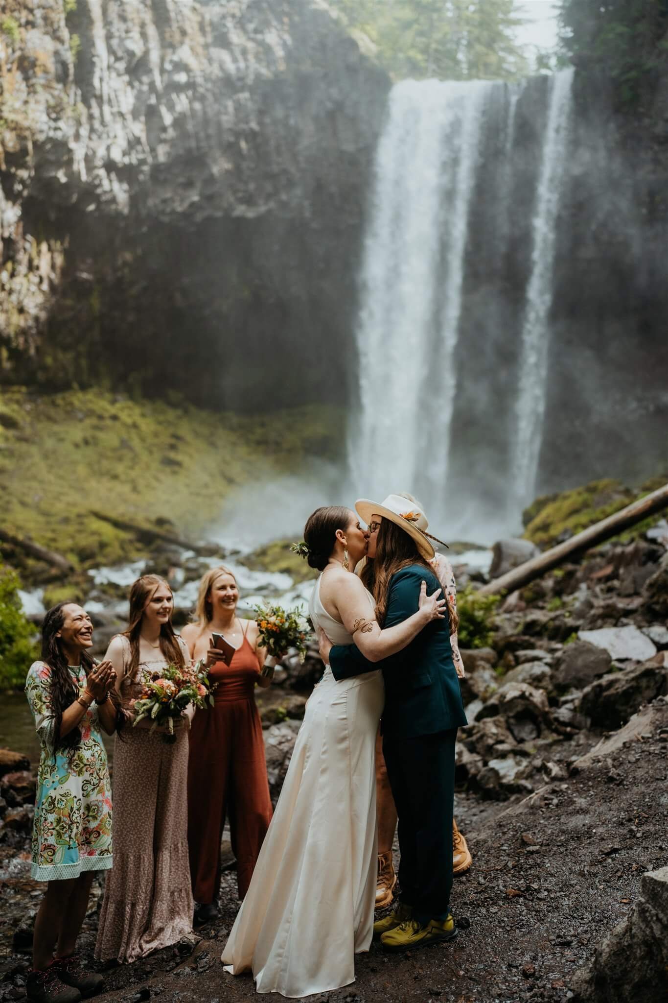 Brides kiss during waterfall wedding at Mt Hood