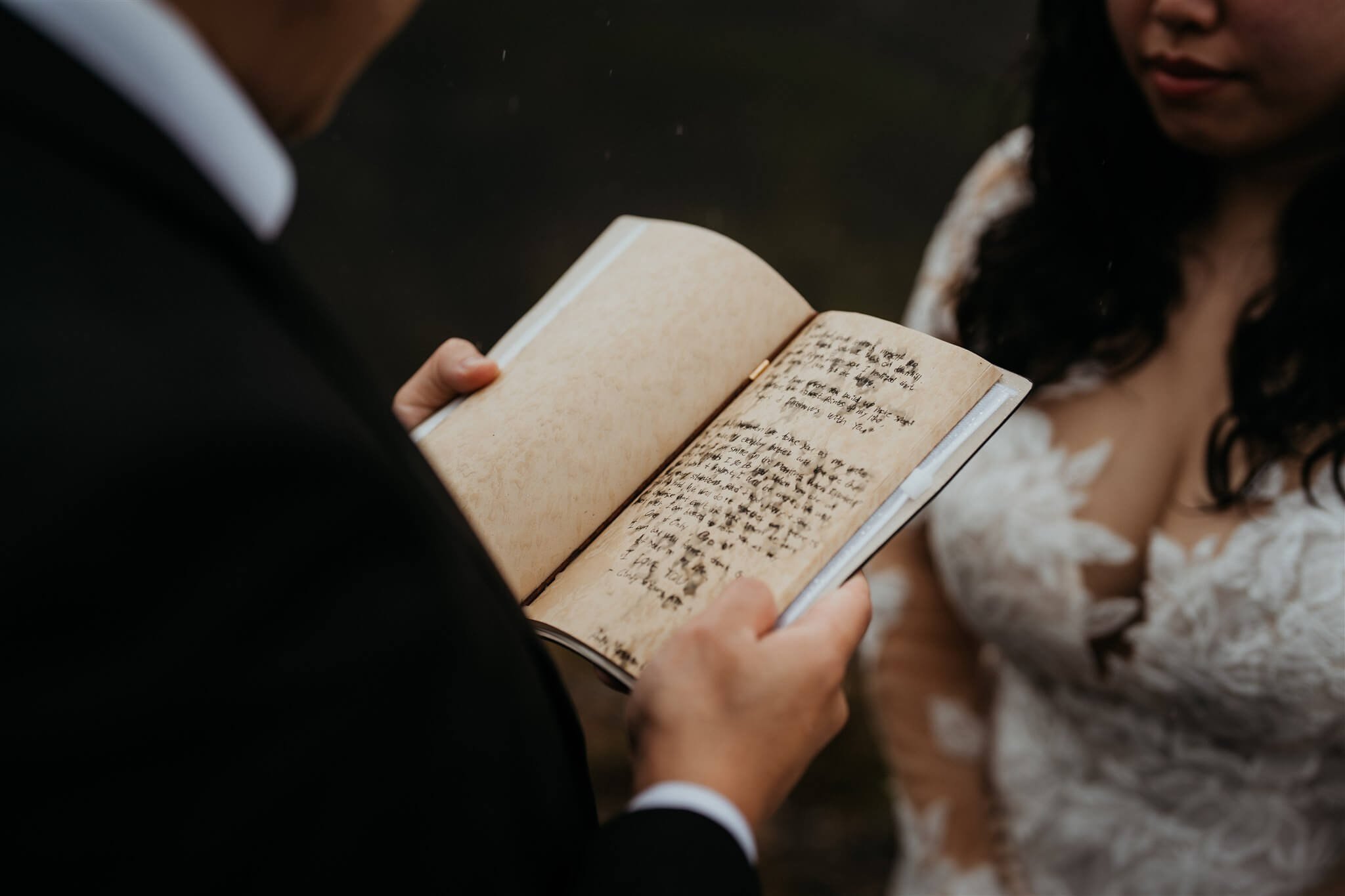 Groom reading personal vows while eloping in Iceland