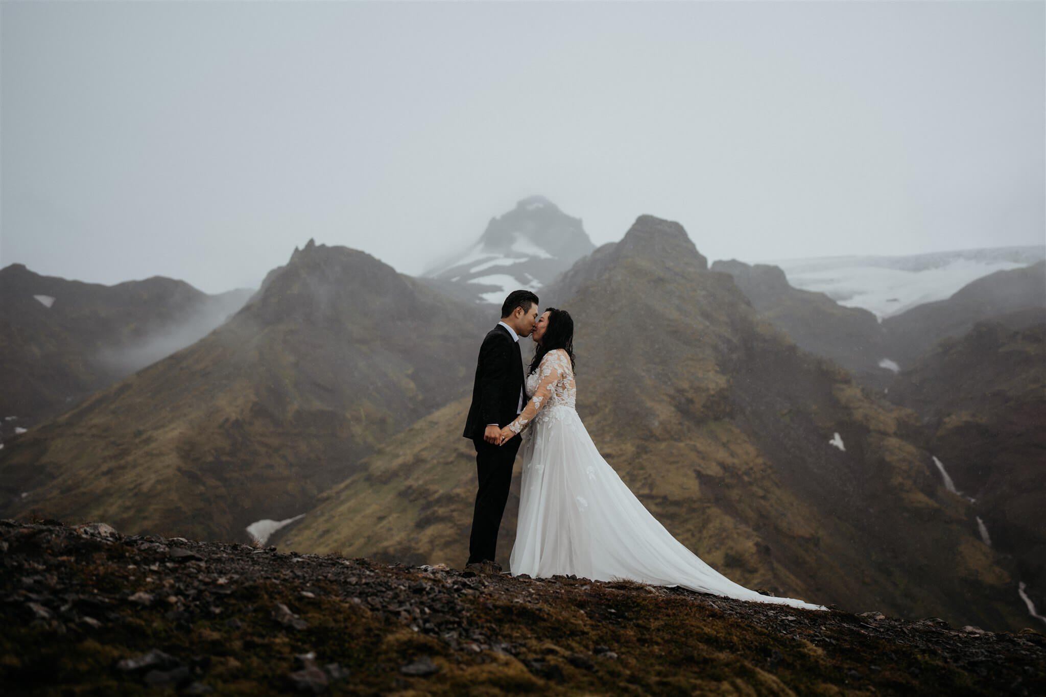 Bride and groom kiss during Iceland elopement ceremony
