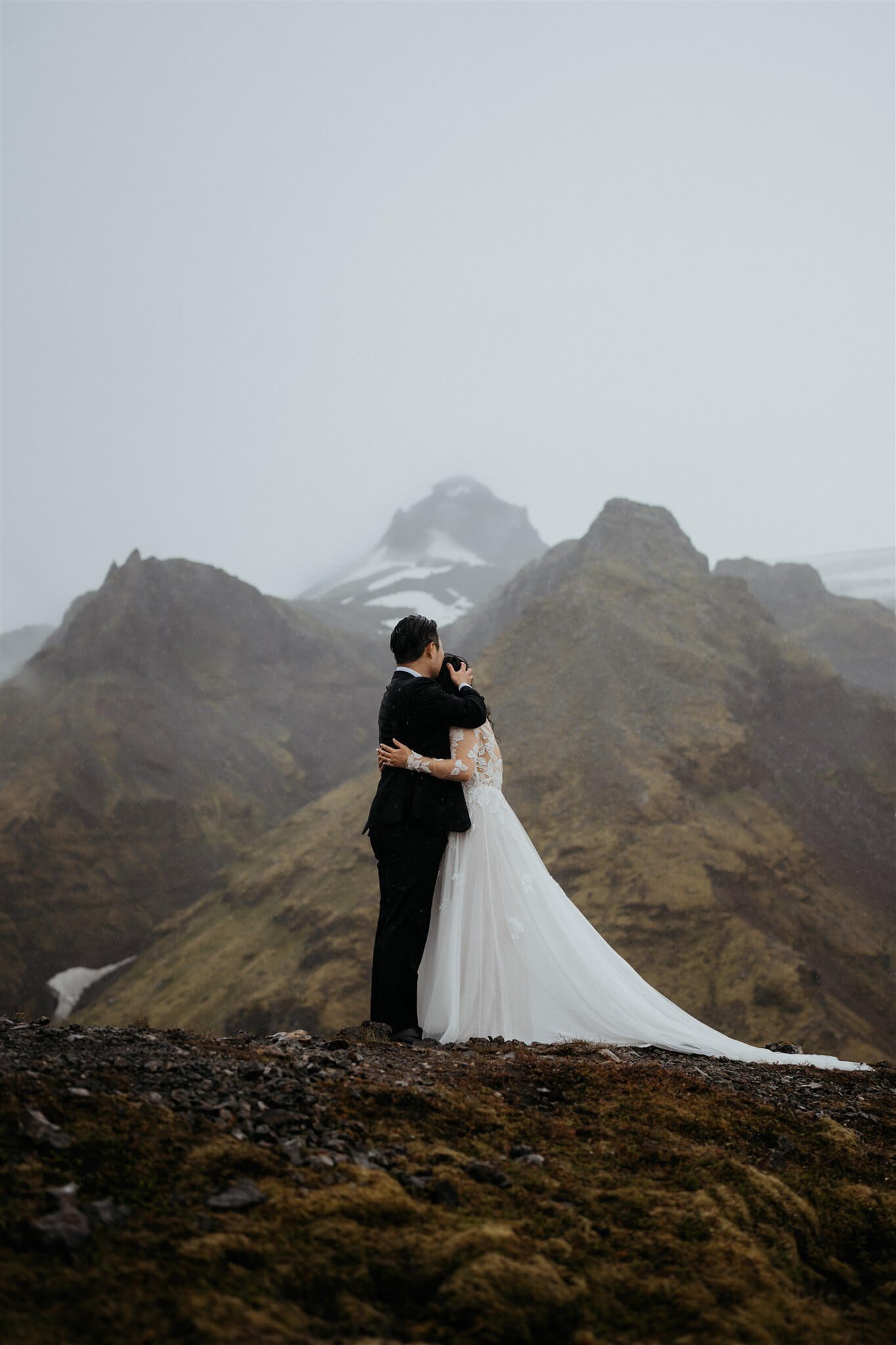 Bride and groom hug after eloping in Iceland