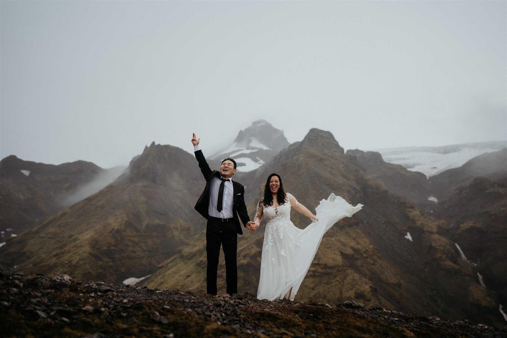 Bride and groom cheer after eloping in Iceland