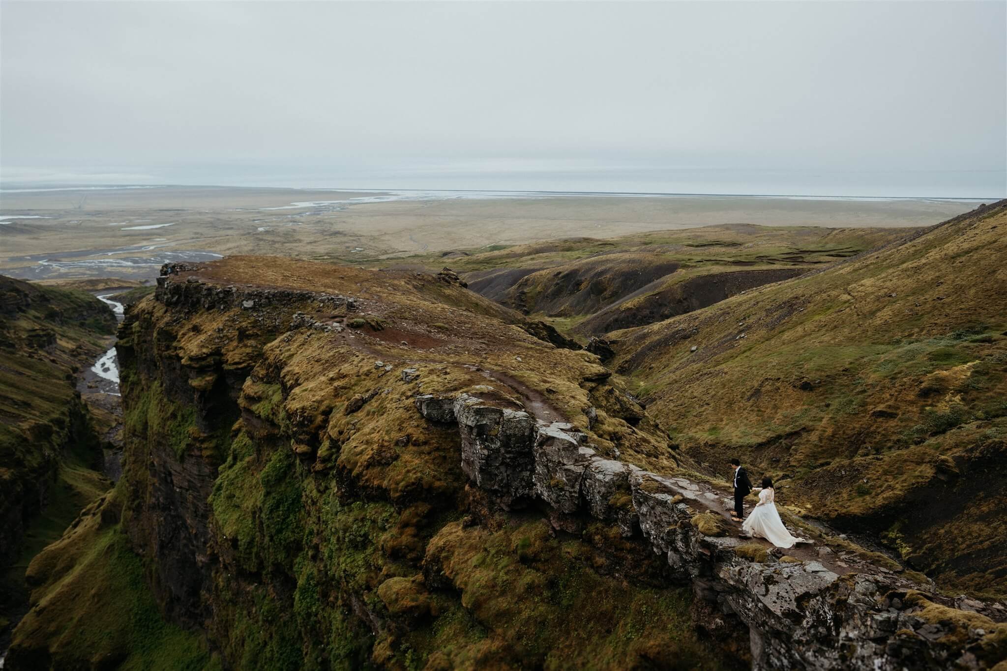 Bride and groom hiking a trail at their elopement in Iceland