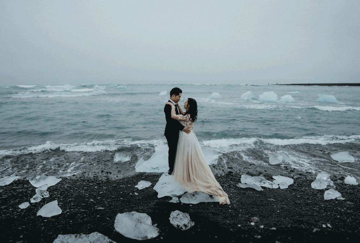Bride and groom couple portraits on a black sand beach after they elope in Iceland