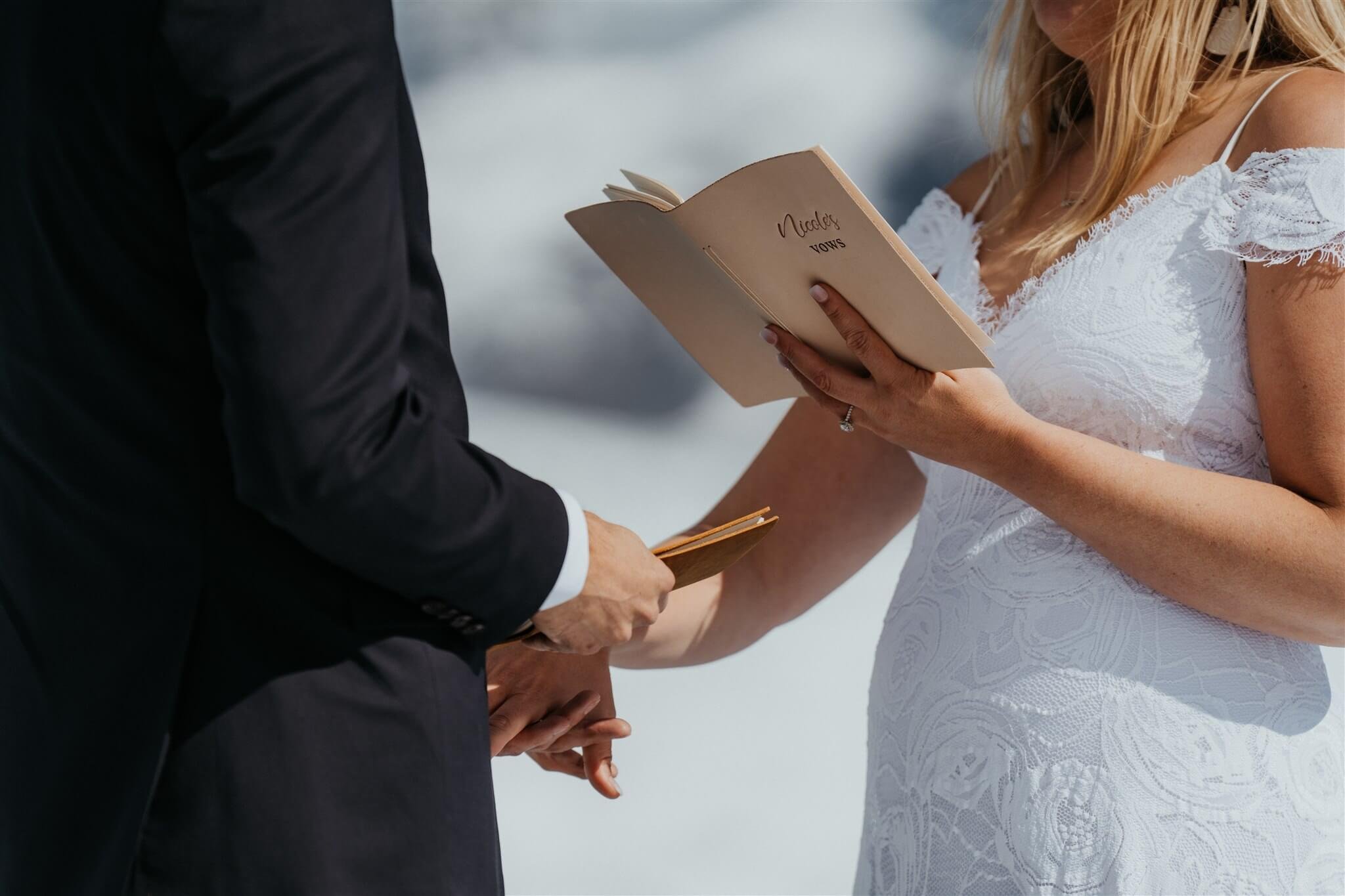 Bride and groom exchange vows during outdoor elopement ceremony on an Alaskan glacier