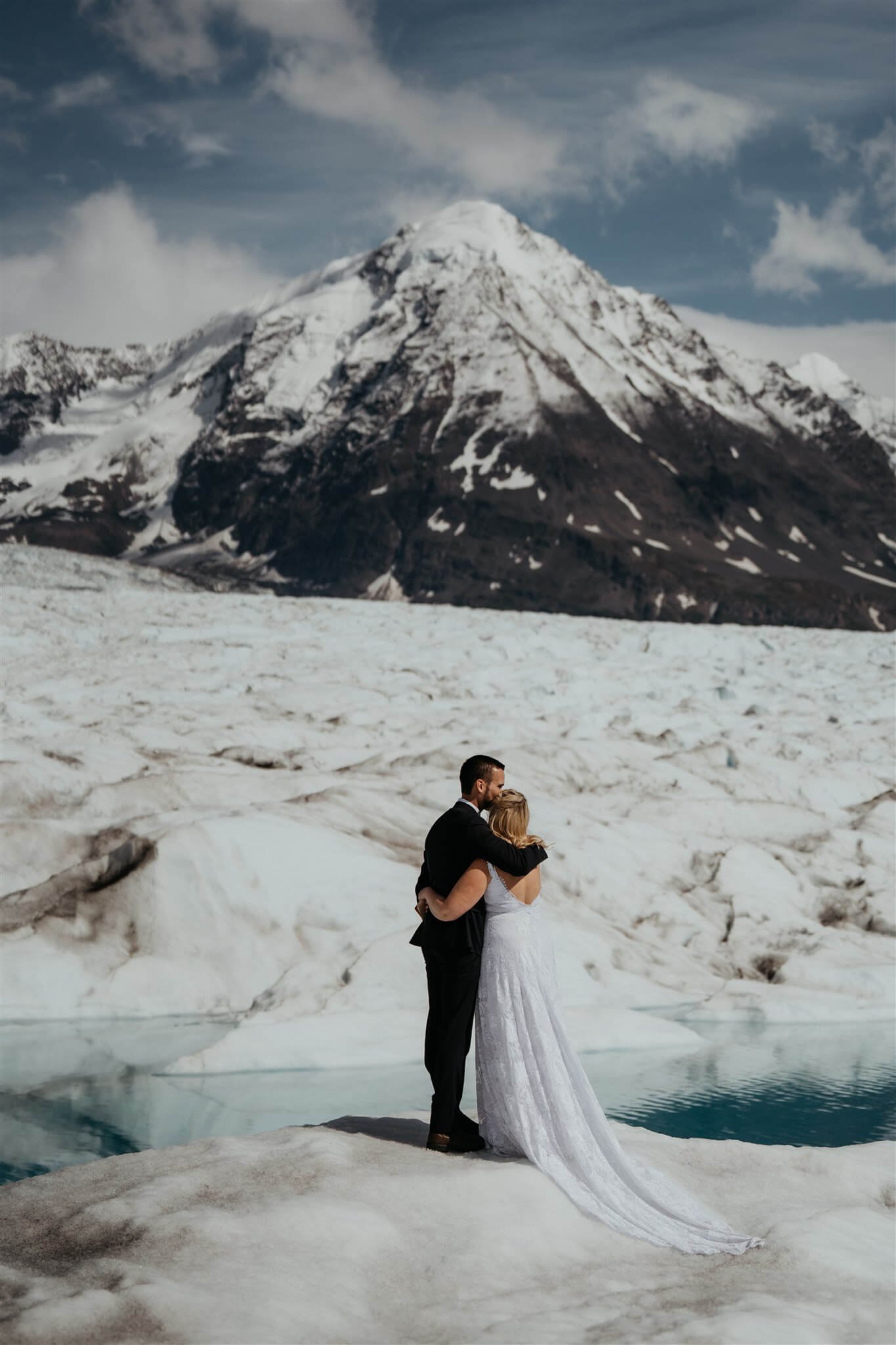 Bride and groom exchange vows during outdoor elopement ceremony on an Alaskan glacier