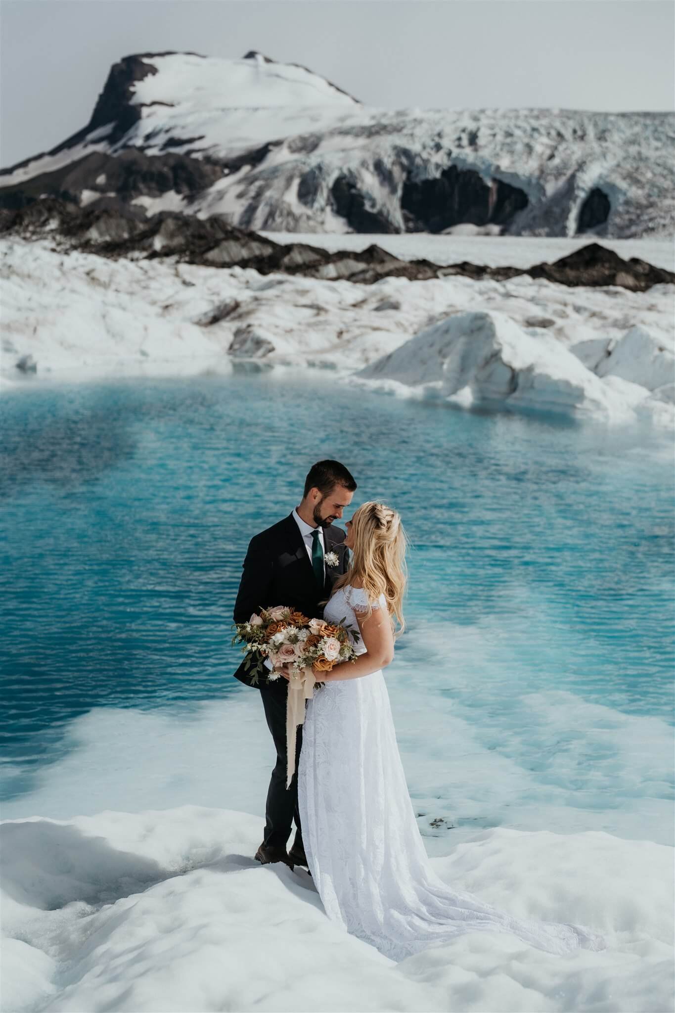 Bride and groom couple portraits during helicopter elopement in Alaska