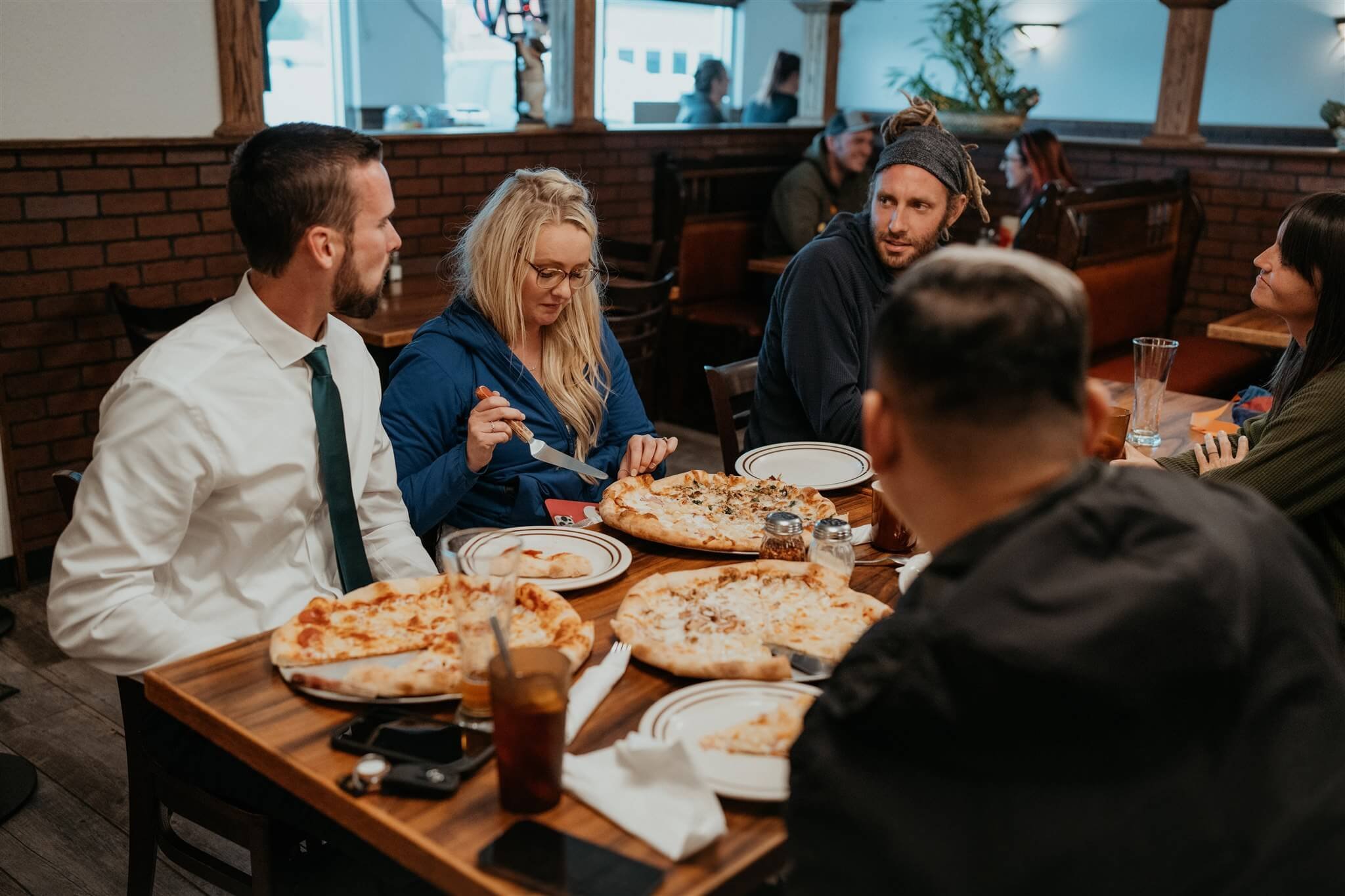 Bride and groom eat pizza to celebrate after their Alaska helicopter elopement