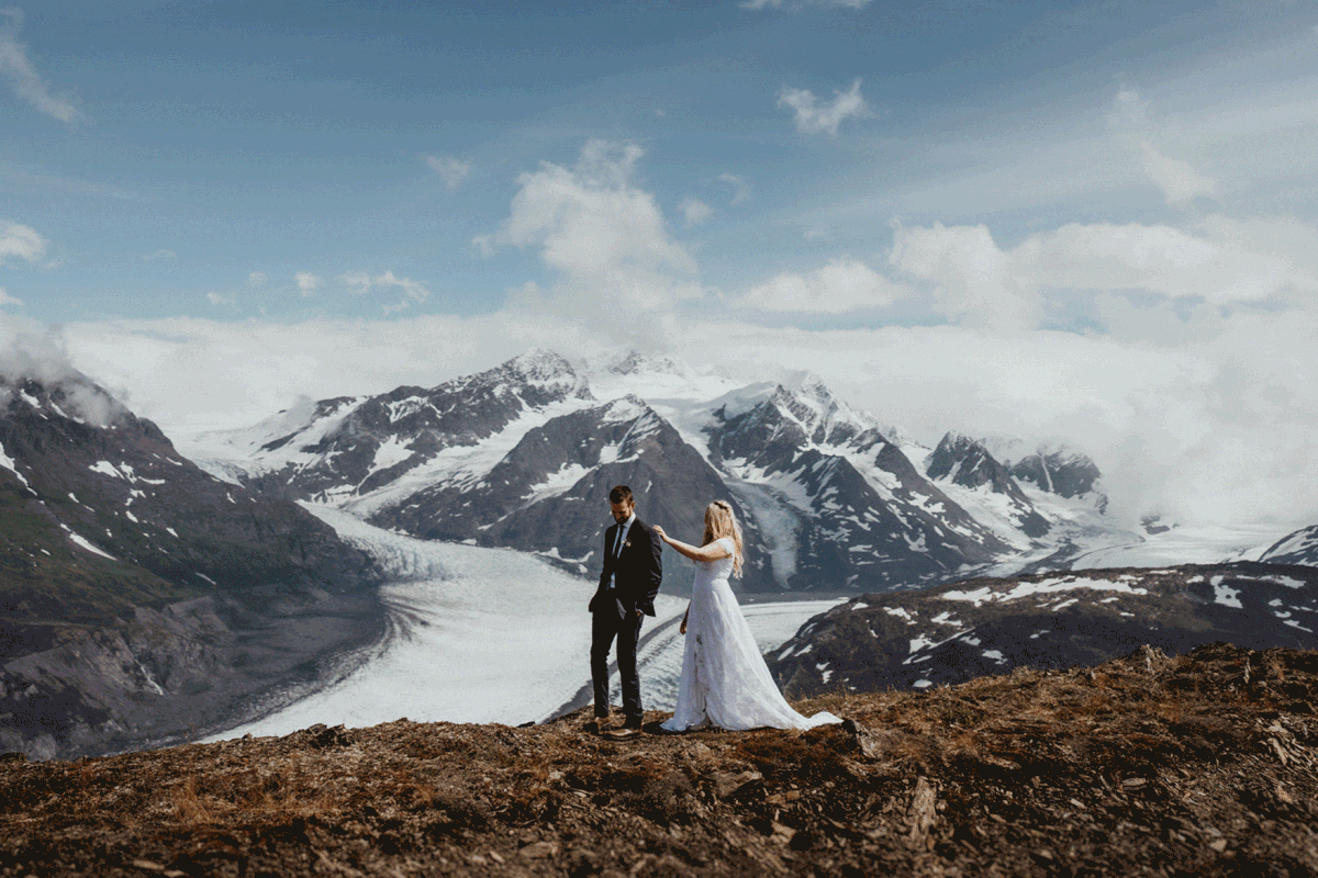 Bride and groom first look overlooking a glacier in Alaska
