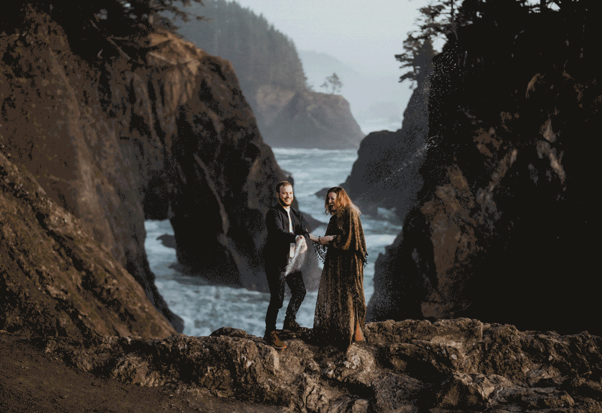 Couple popping champagne during anniversary photos on the Oregon Coast