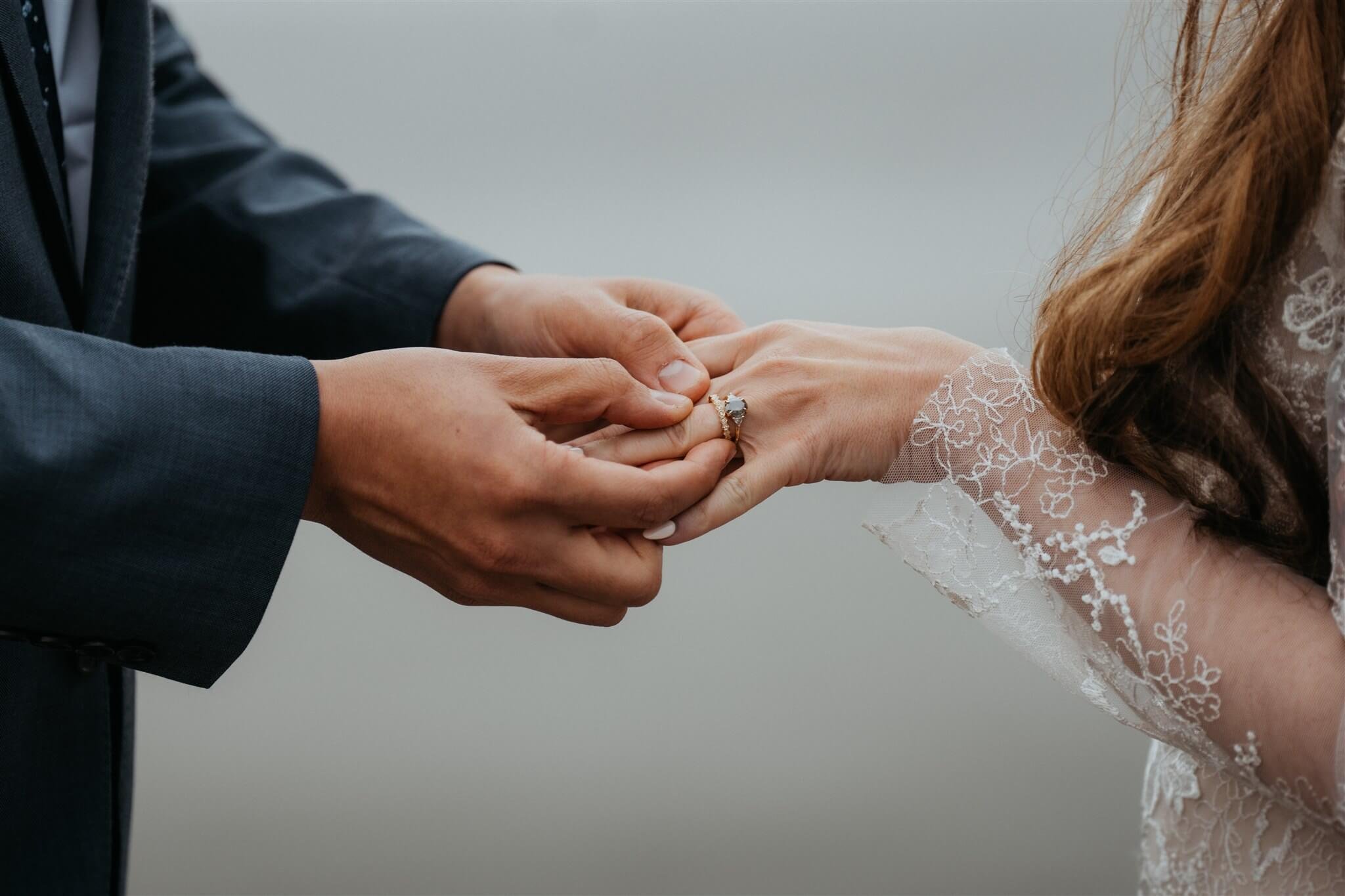 Bride and groom exchange rings at La Push Beach elopement