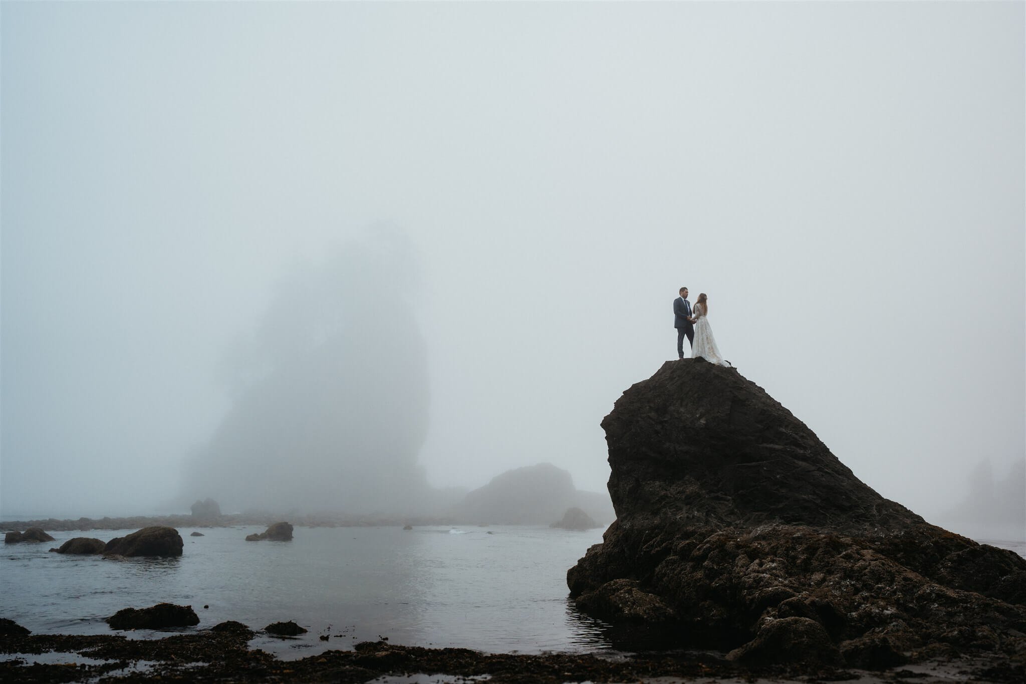 Moody couple portraits at La Push Beach after eloping with family