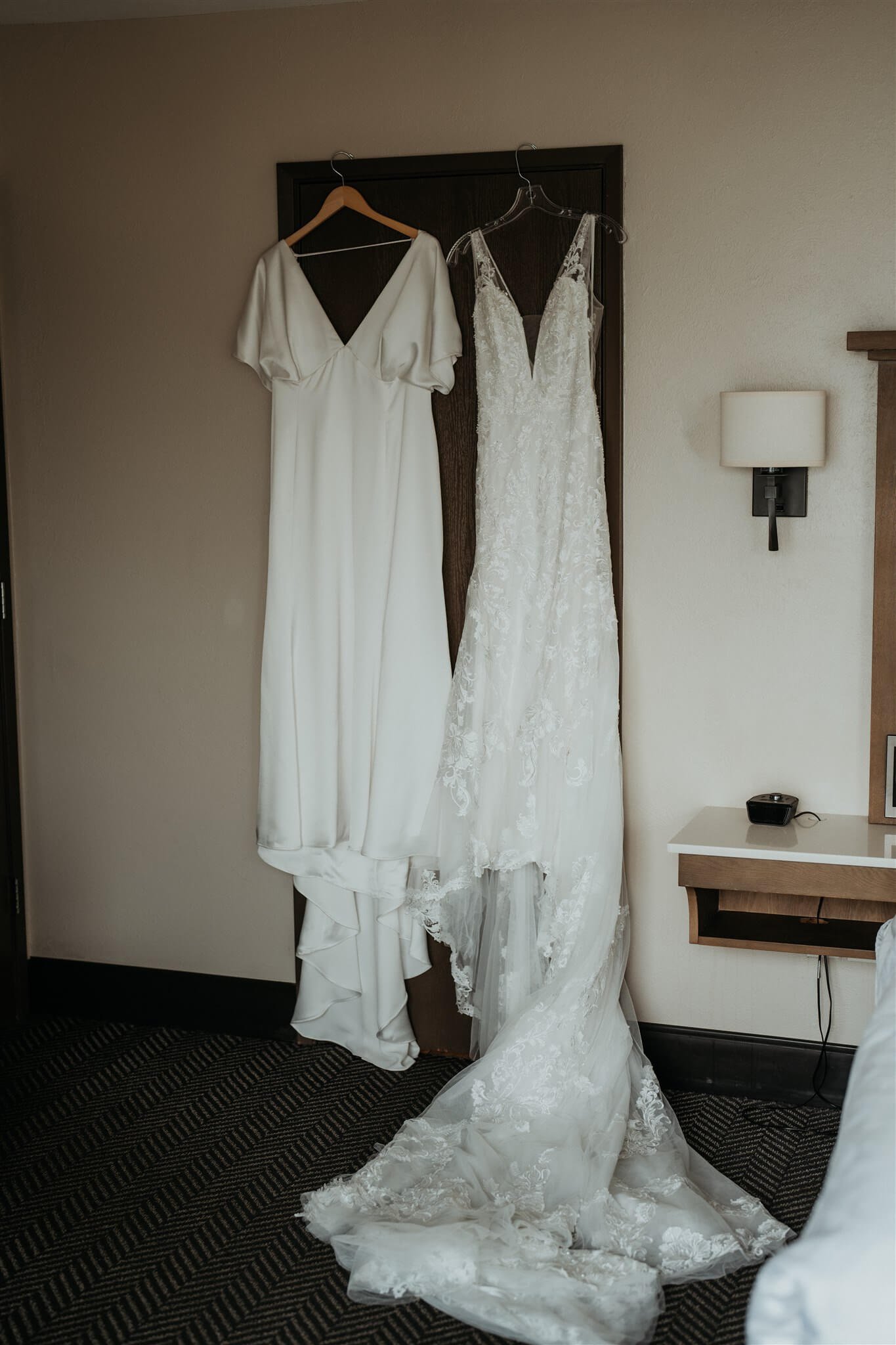 two brides wedding dresses hanging side by side
