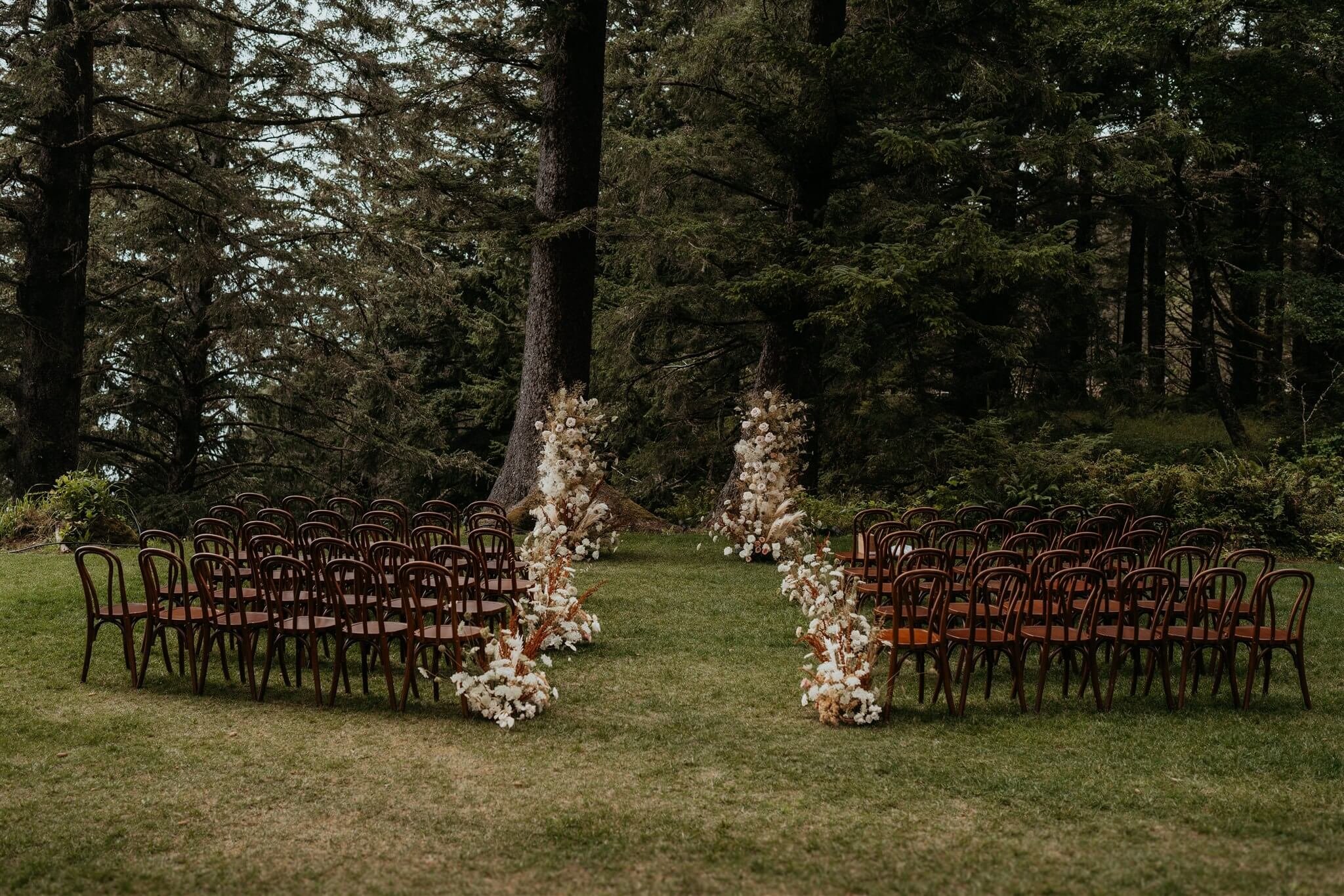 Elegant wedding ceremony chairs at flower-filled wedding