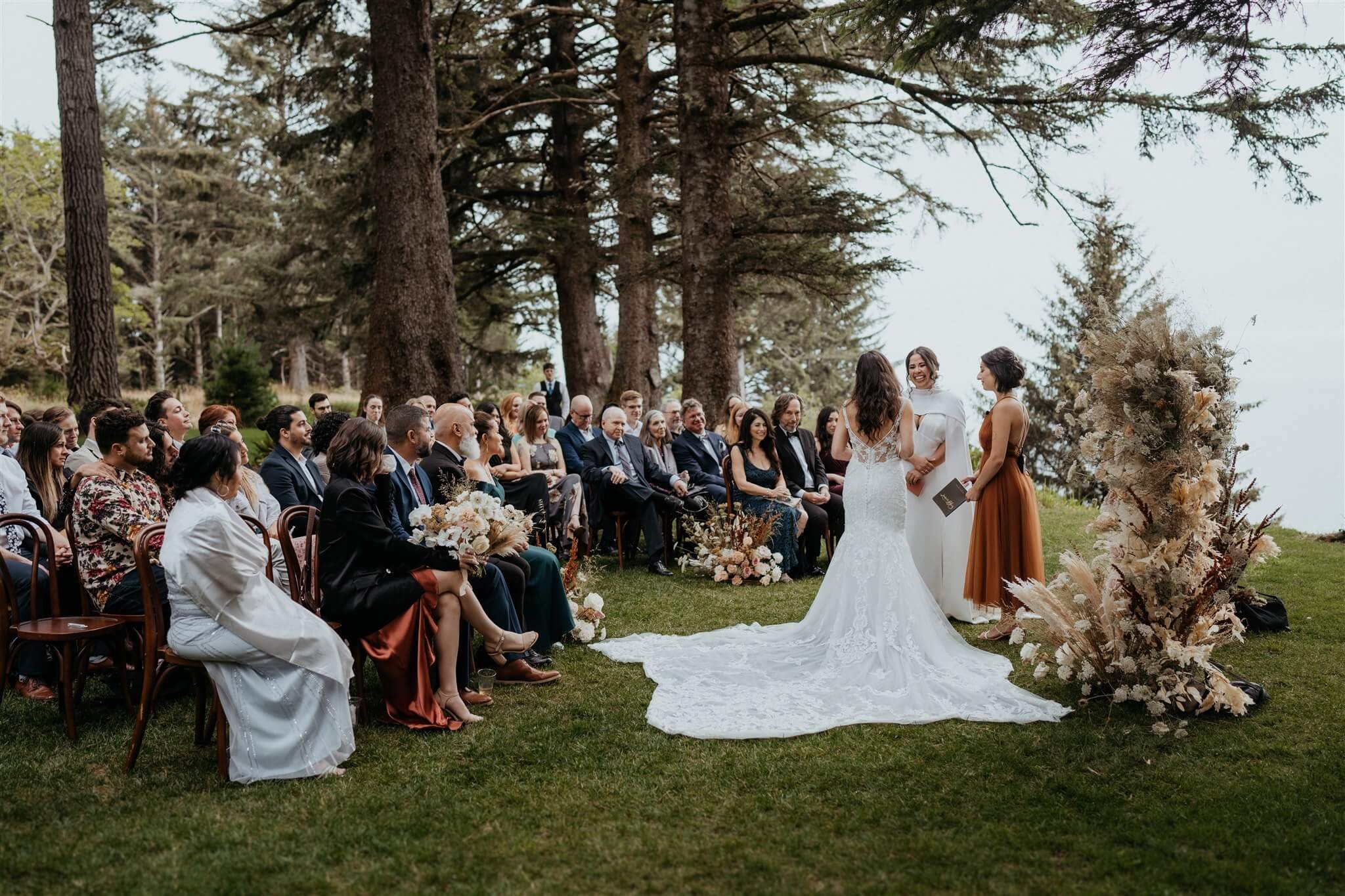 Two brides exchange vows at elegant wedding ceremony on the Oregon Coast
