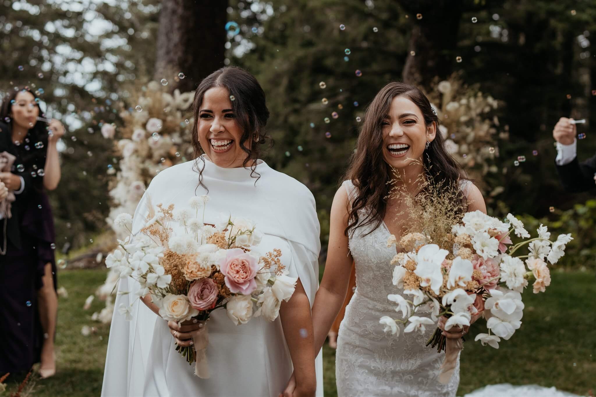 Two brides exit elegant wedding ceremony