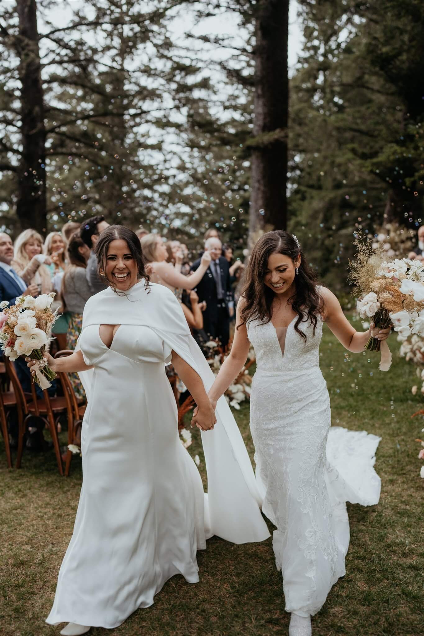 Two brides exit elegant wedding ceremony