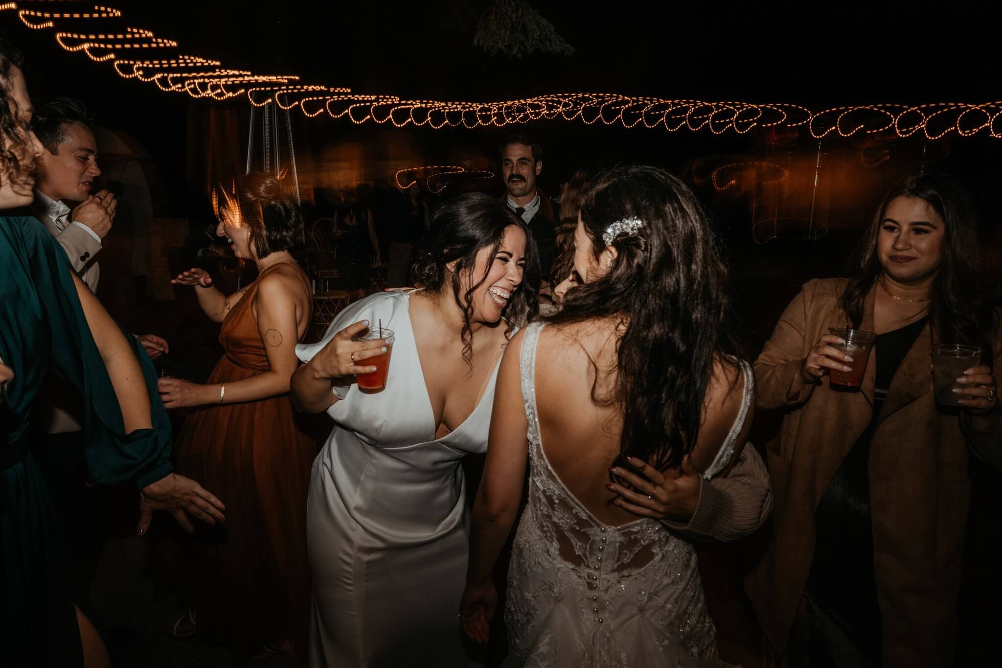 Brides dance with guests at two day wedding